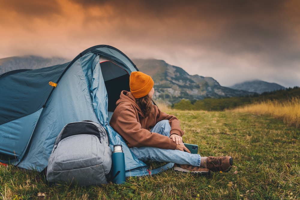 woman sitting in a small tent