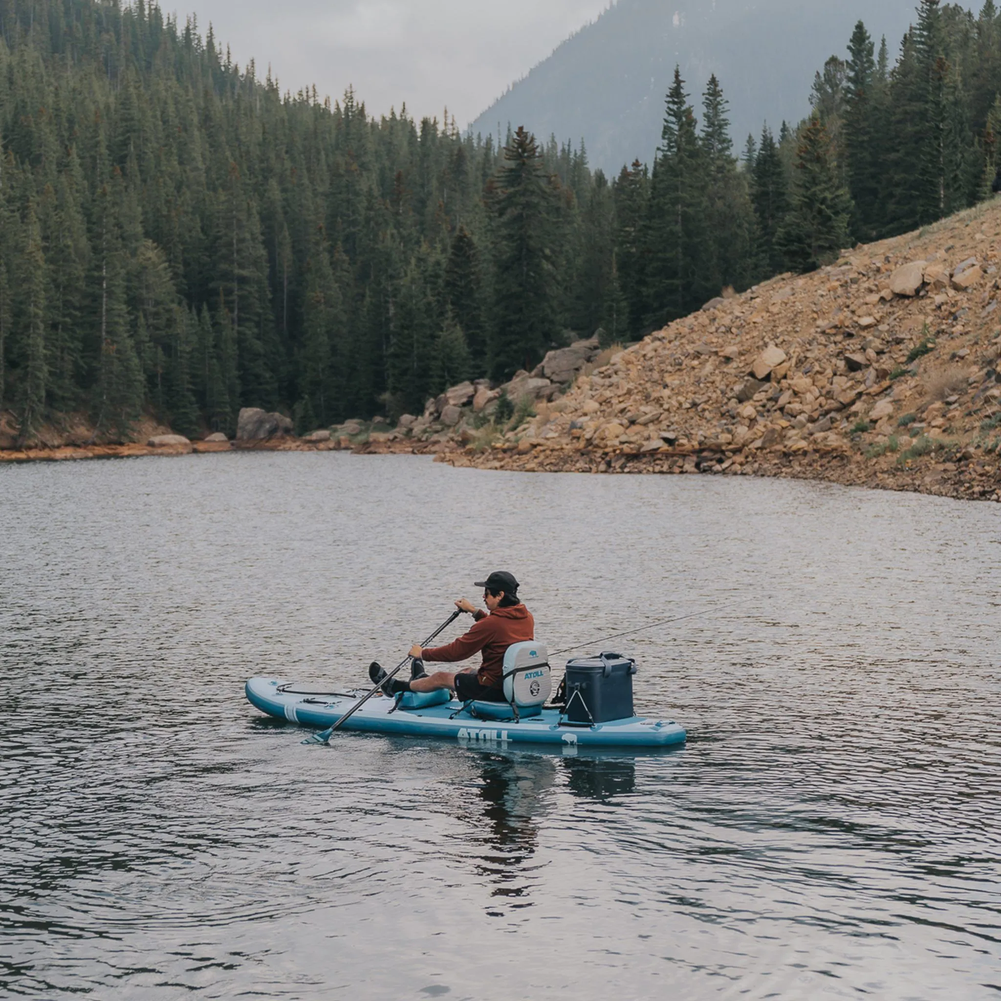 man using atoll outrider on lake