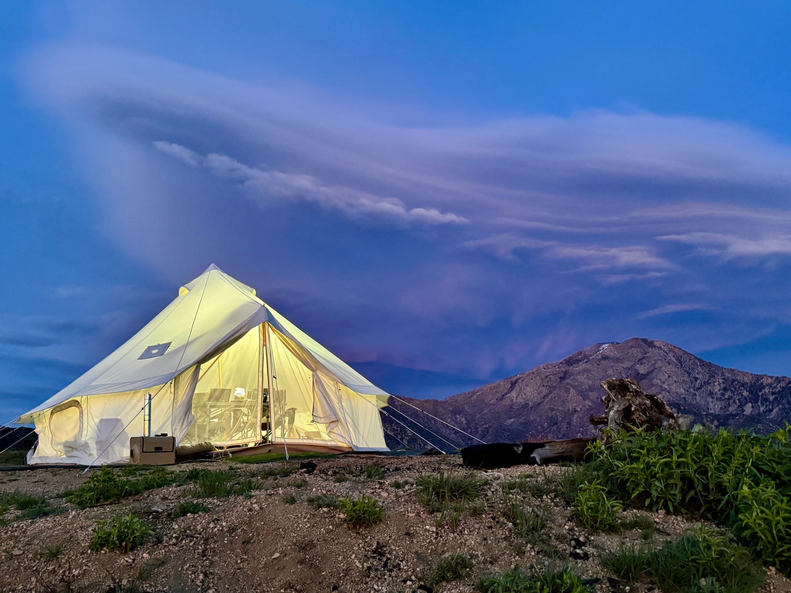 Elk Mountain Bell tent on top of a mountain with dramatic clouds
