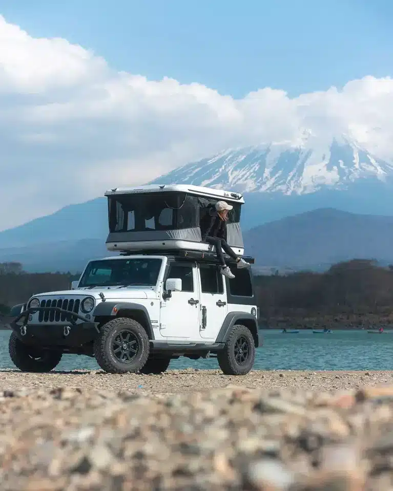 James Baroud Evasion Review White Jeep Wrangler with rooftop tent parked lakeside as Mount Fuji rises snow-capped in the background