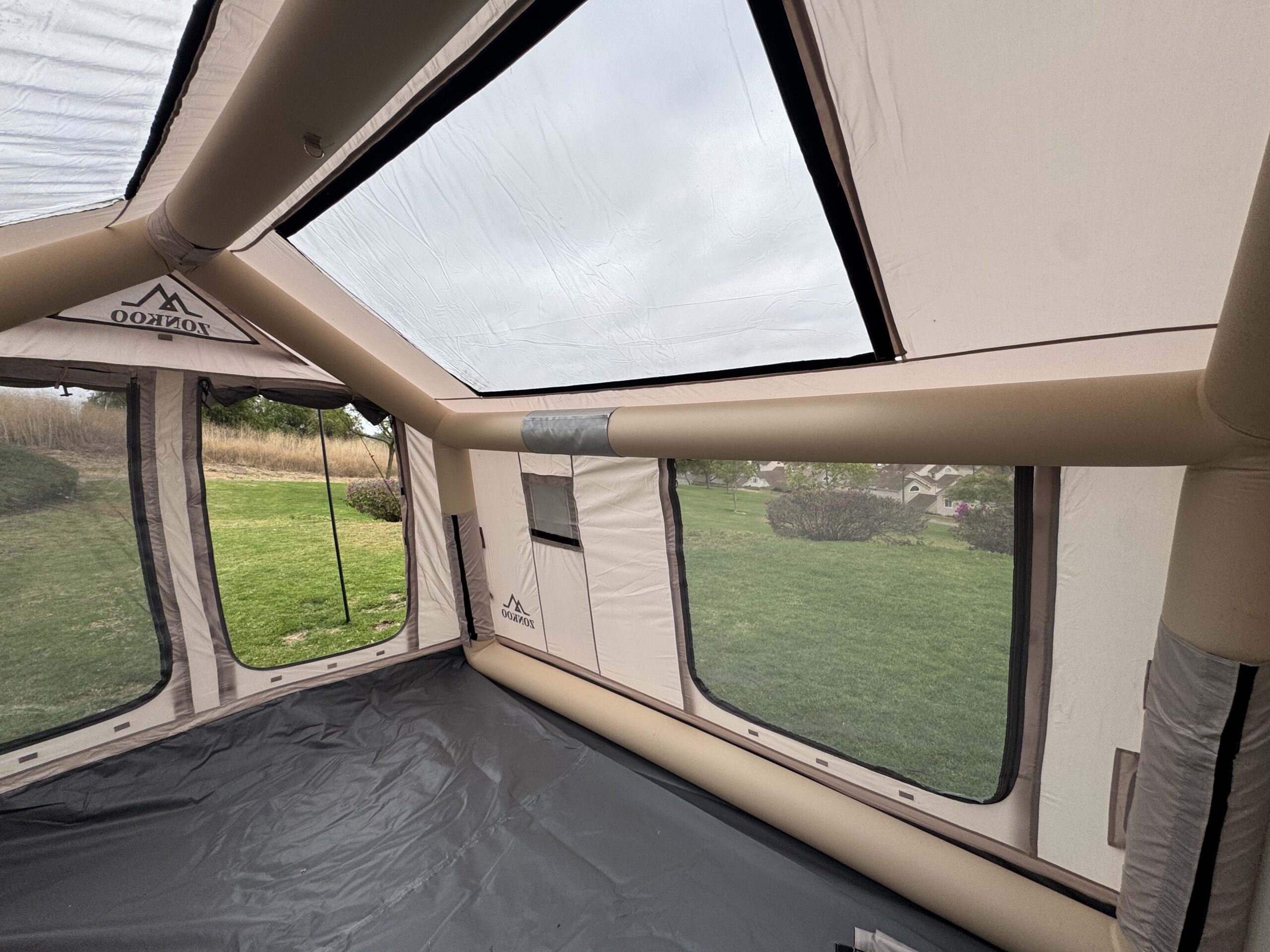 Interior view of the Zonkoo Orion inflatable tent showing its large mesh skylight and window panels