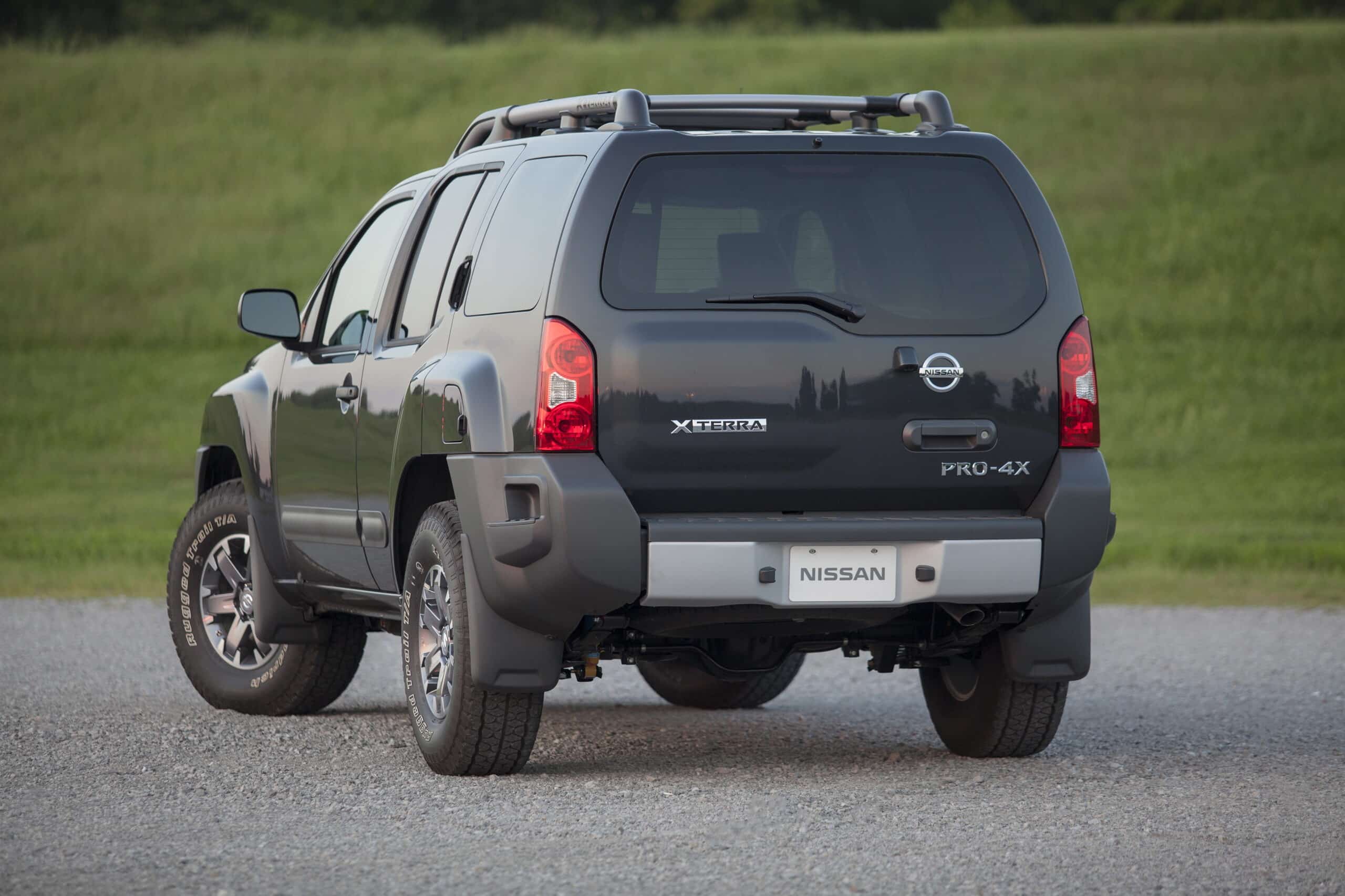Rear view of a black Nissan Xterra Pro-4X showing its roof rack, taillights, and XTERRA badge