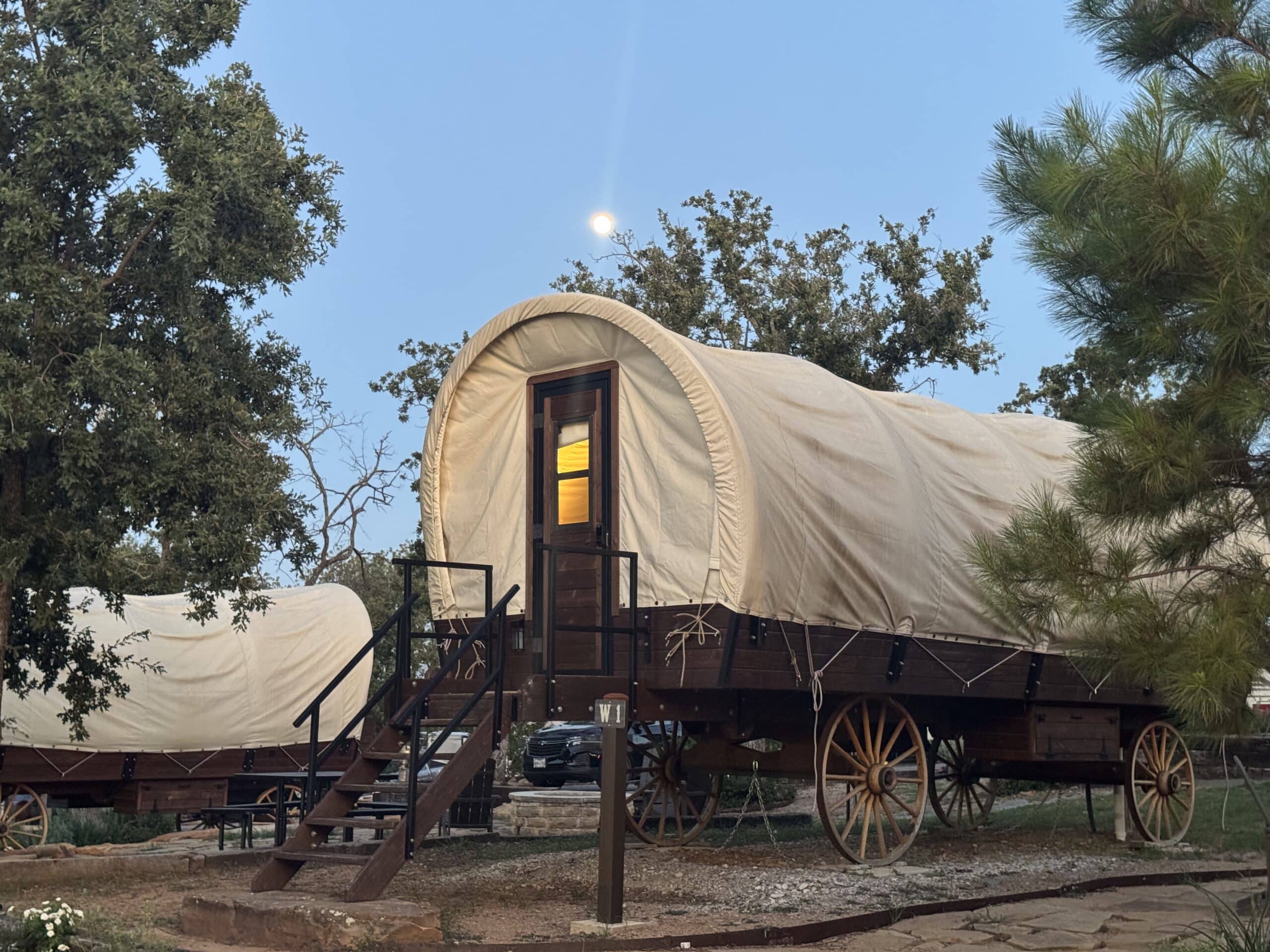 This wagon has two queen-size beds and a full bathroom inside of it. Very unique cabin offered at Camp Quitcherbichin