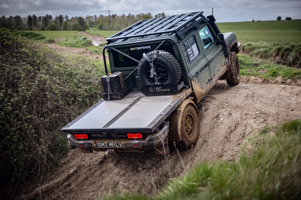 Rear view of the Grenadier MRLV flatbed carrying a spare wheel and SMT Defence storage on a descent