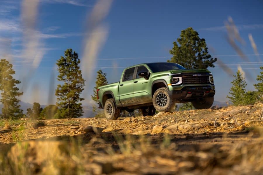 2027 Silverado 1500 Trail Boss in green Trillium Metallic on a rocky trail