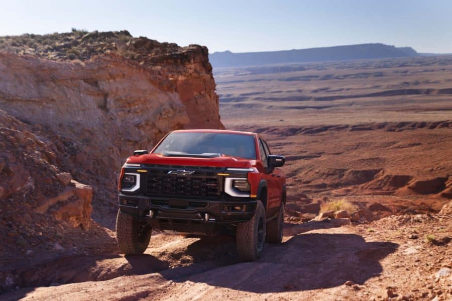 Chevrolet Silverado 1500 ZR2 Bison in Apex Red on a desert canyon ledge