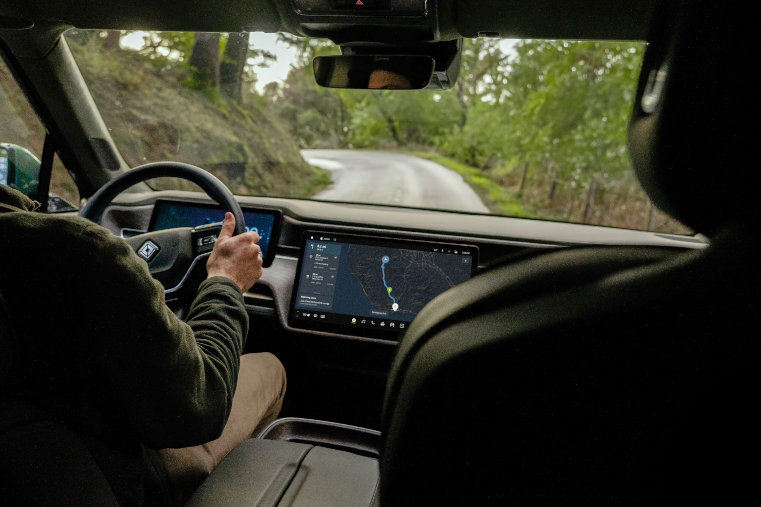 Interior of a Rivian showing the in-vehicle navigation and charging display