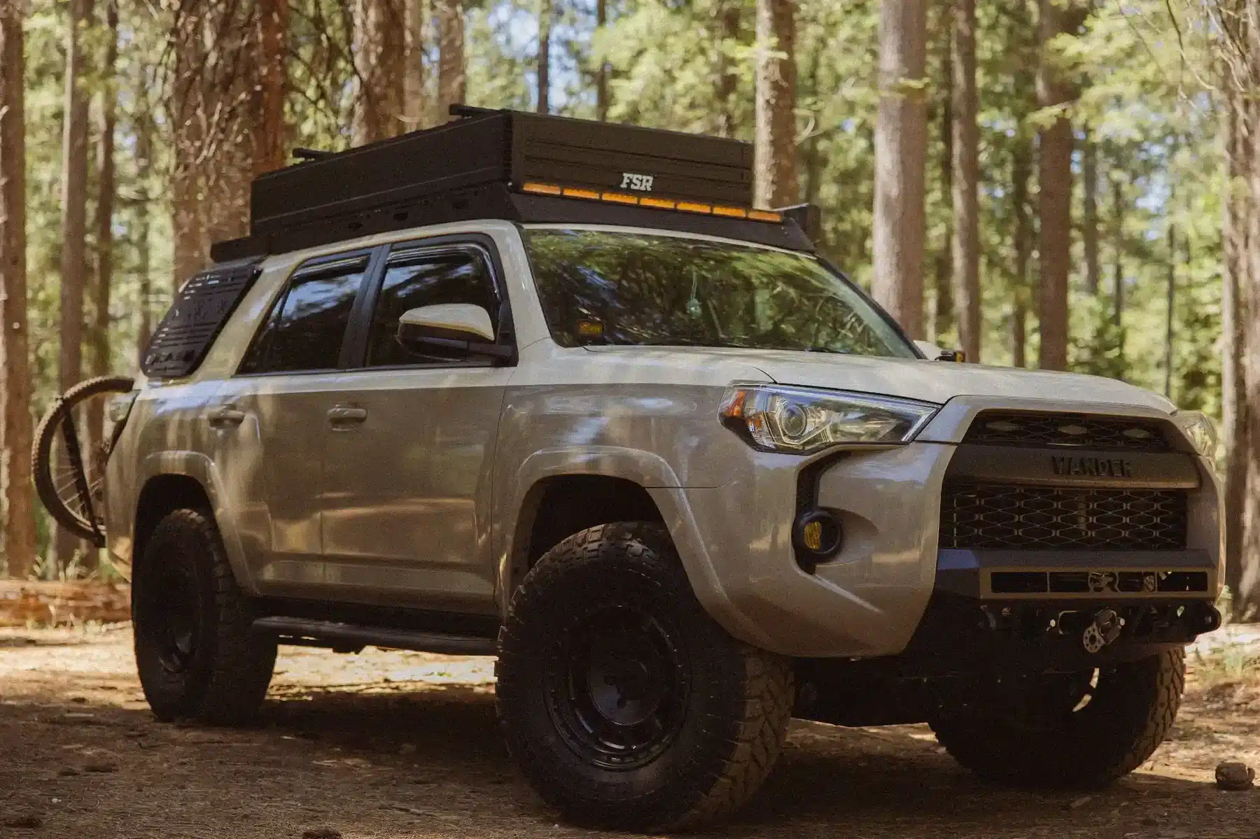 FSR Nova King rooftop tent on a Toyota 4Runner with a bike on a forest dirt road