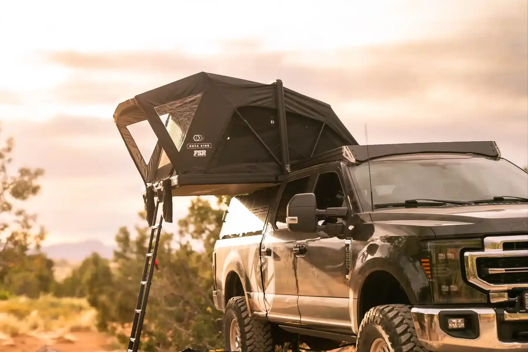 FSR Nova King rooftop tent mounted on a Ford Super Duty truck at dusk