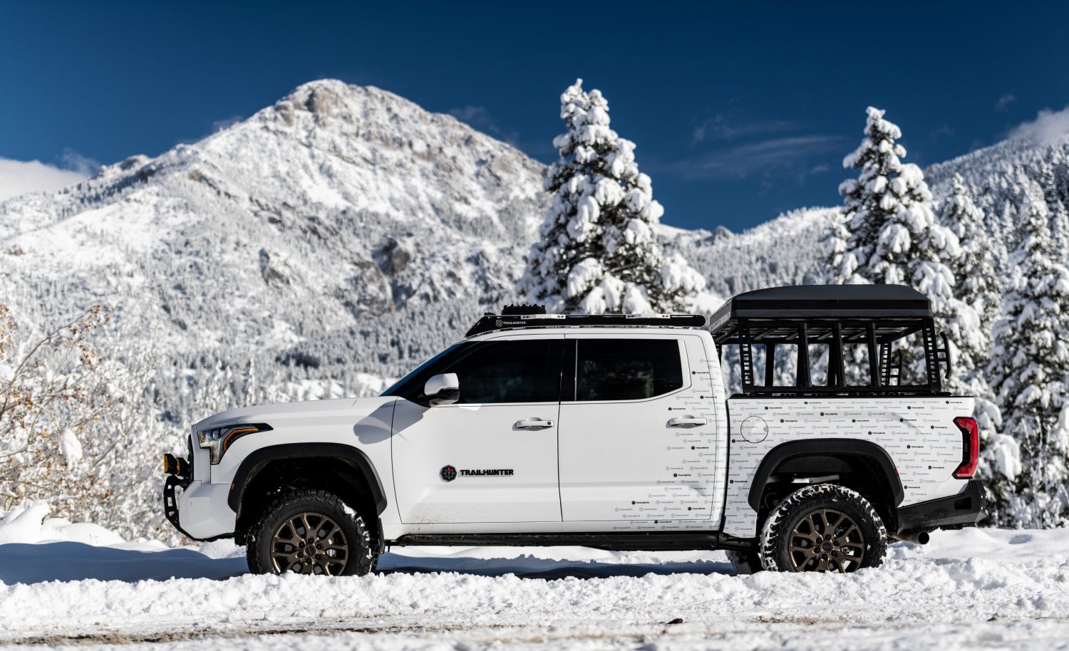 Side profile of the 2027 Toyota Tundra Trailhunter showing its bronze 18-inch wheels and Michelin LTX Trail tires