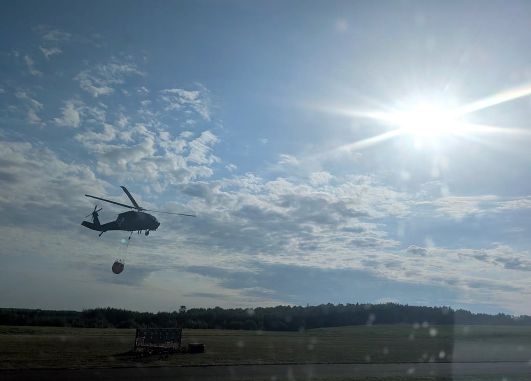 Army National Guard helicopter after a water bucket drop on the Superior National Forest wildfires