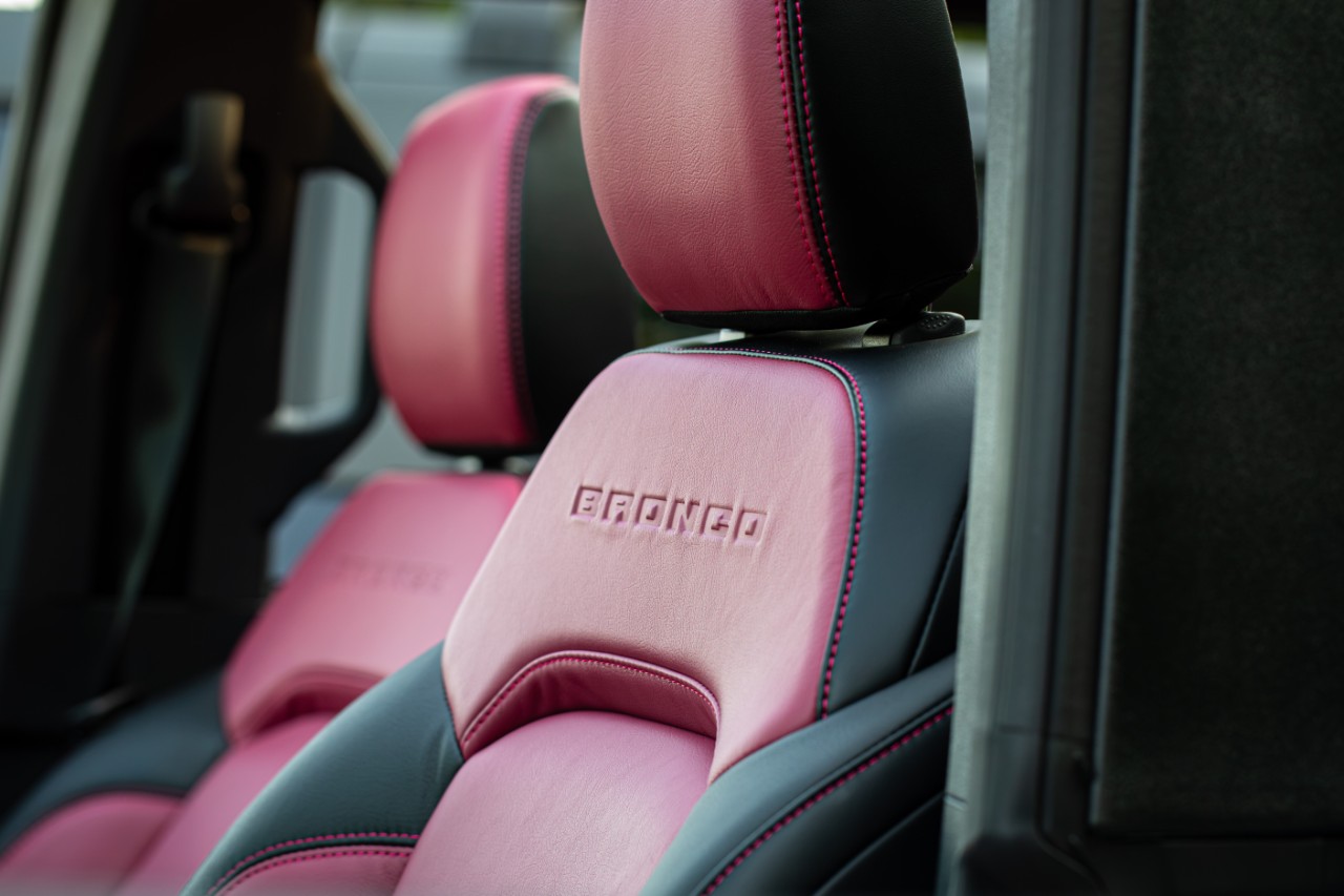 Magenta leather headrest embroidered with the Bronco logo inside a Ford Bronco Desert Rising