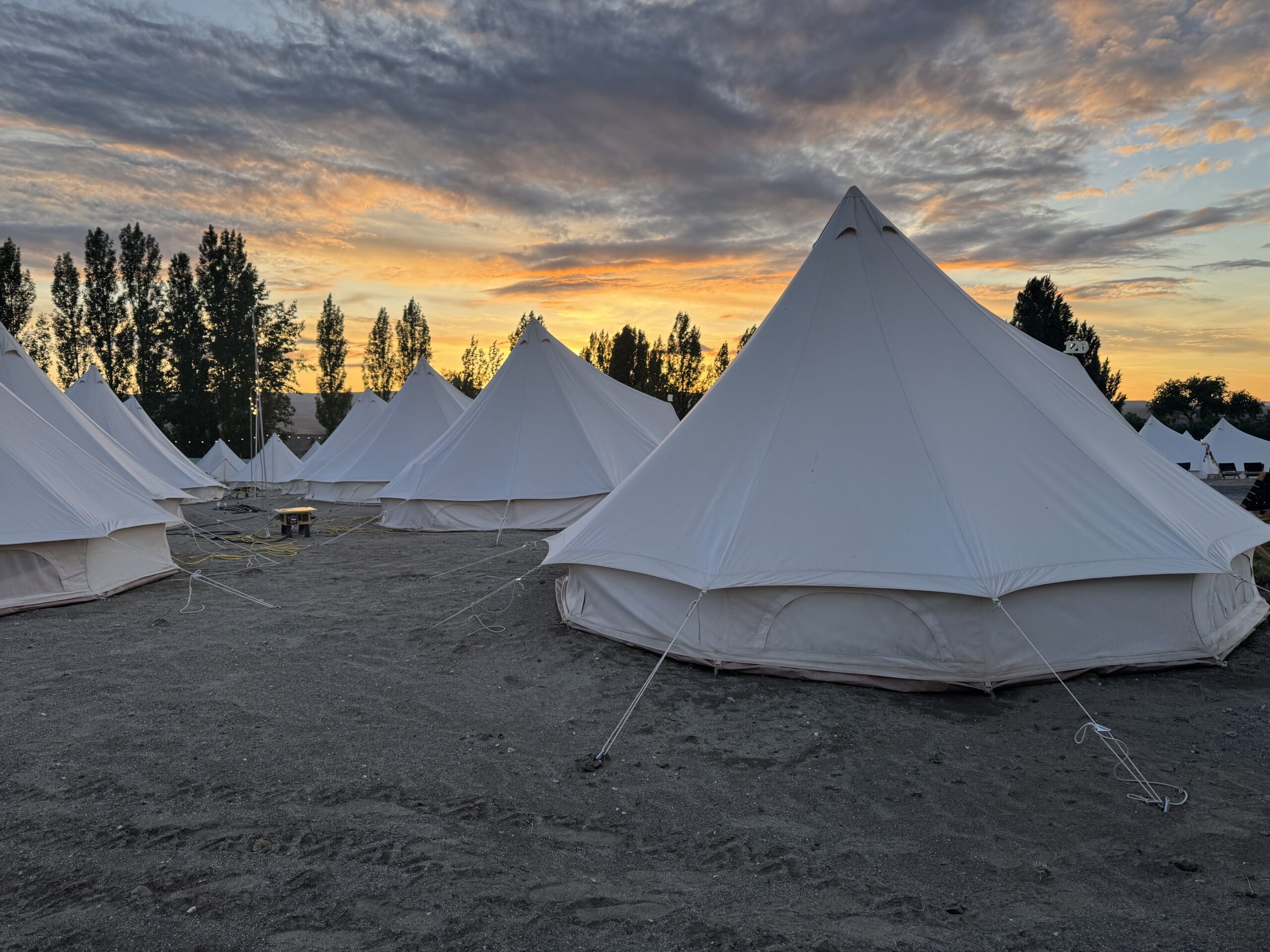 Stout Bell Tents lined up at the Gorge Amphitheater during sunset.