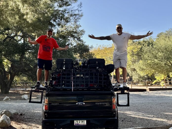 Alex and Michael standing on YASSA STEP mounted on a 2013 Ford Raptor