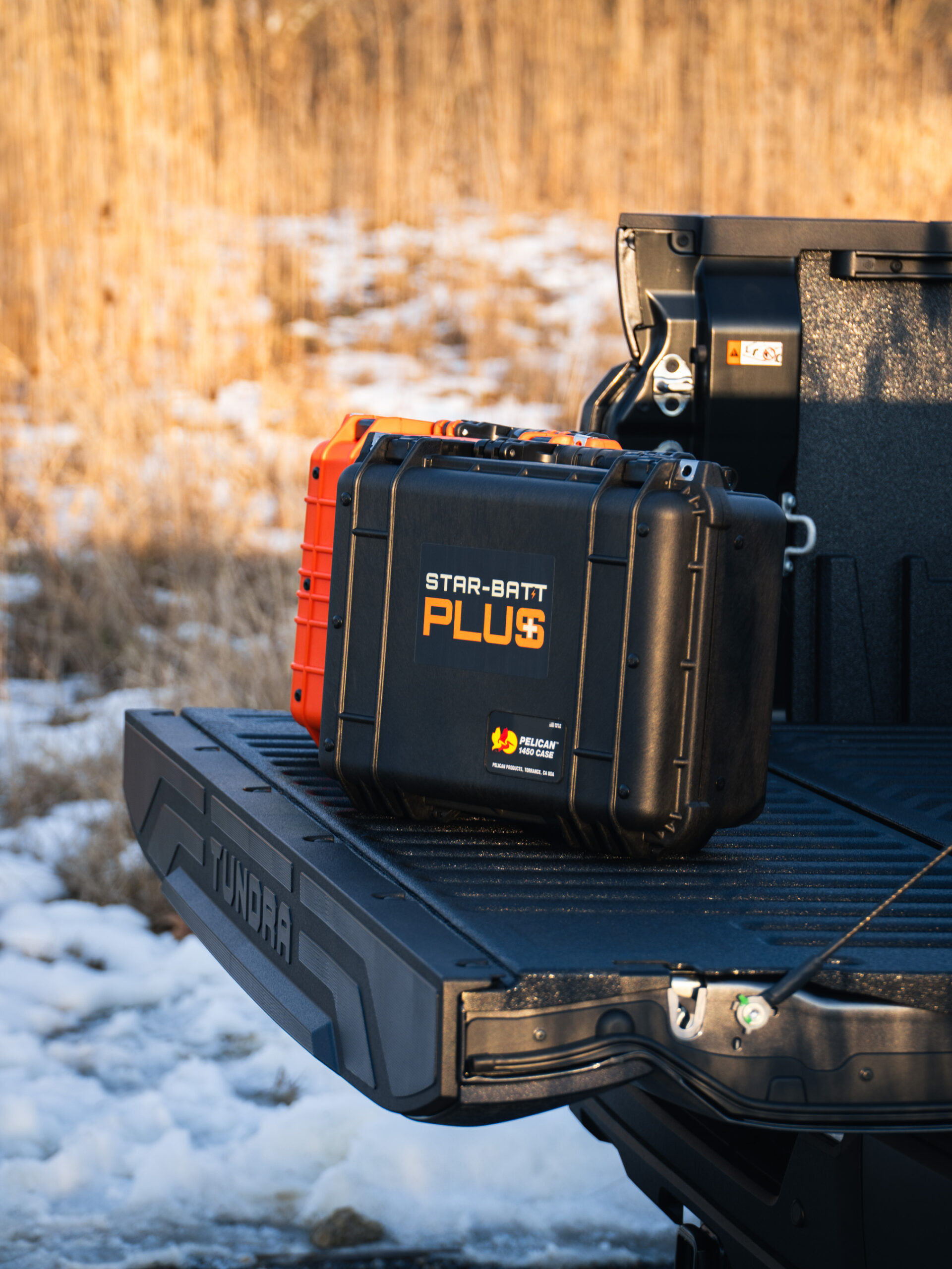 Star-Batt Plus cases in orange and black, built on a Pelican 1450 case