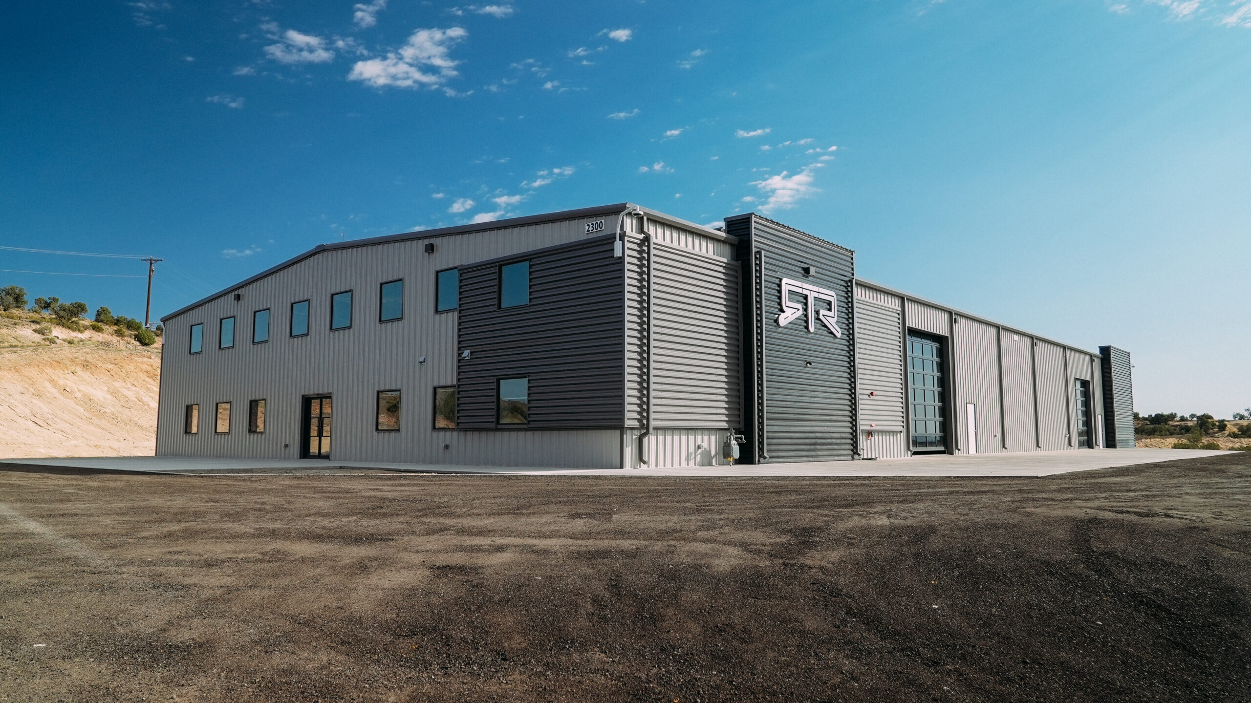 The RTR Vehicles off-road headquarters in Farmington, New Mexico, a two-story metal shop building on high-desert ground