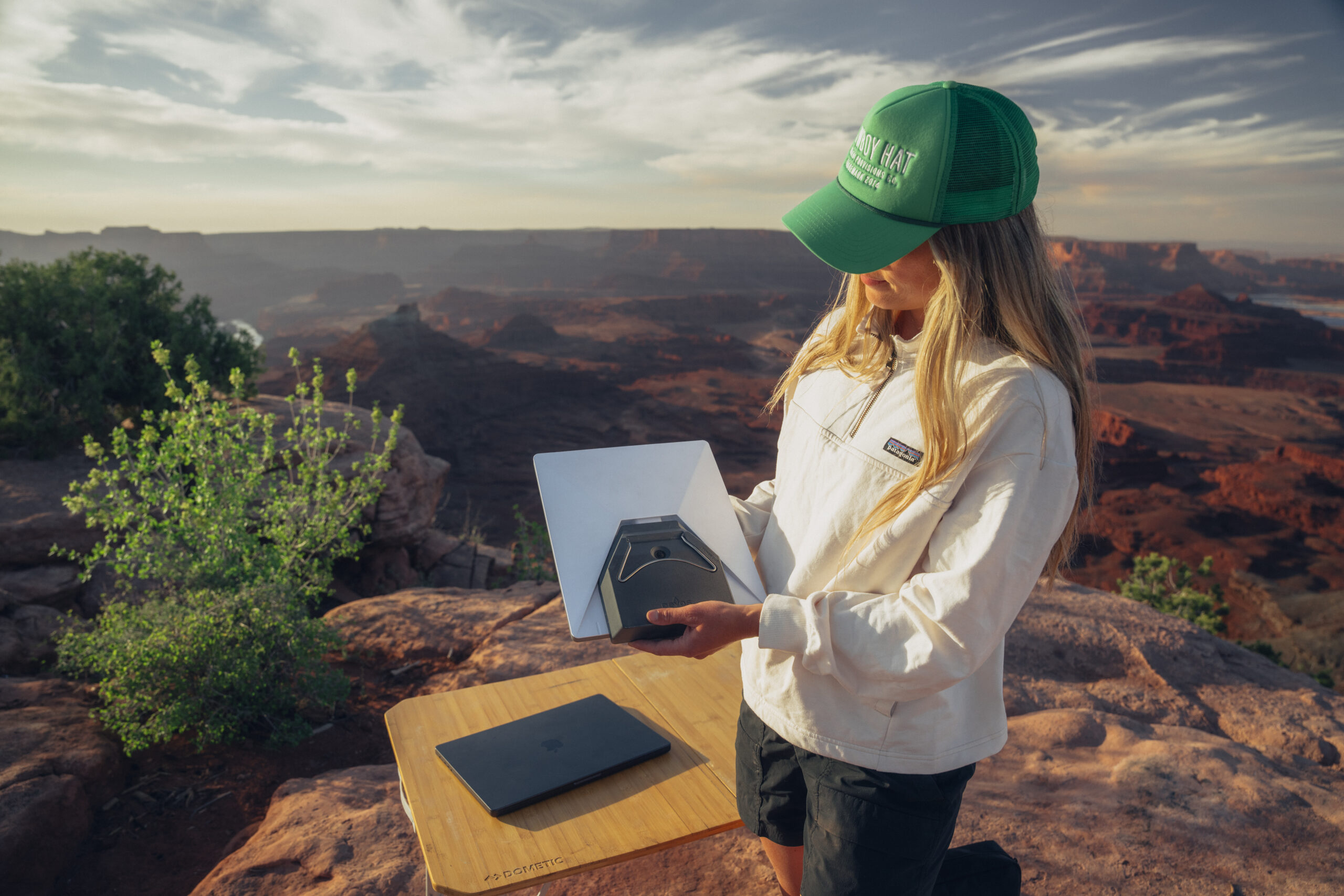Starlink Mini dish set up on red rock at a canyon overlook near Moab, Utah