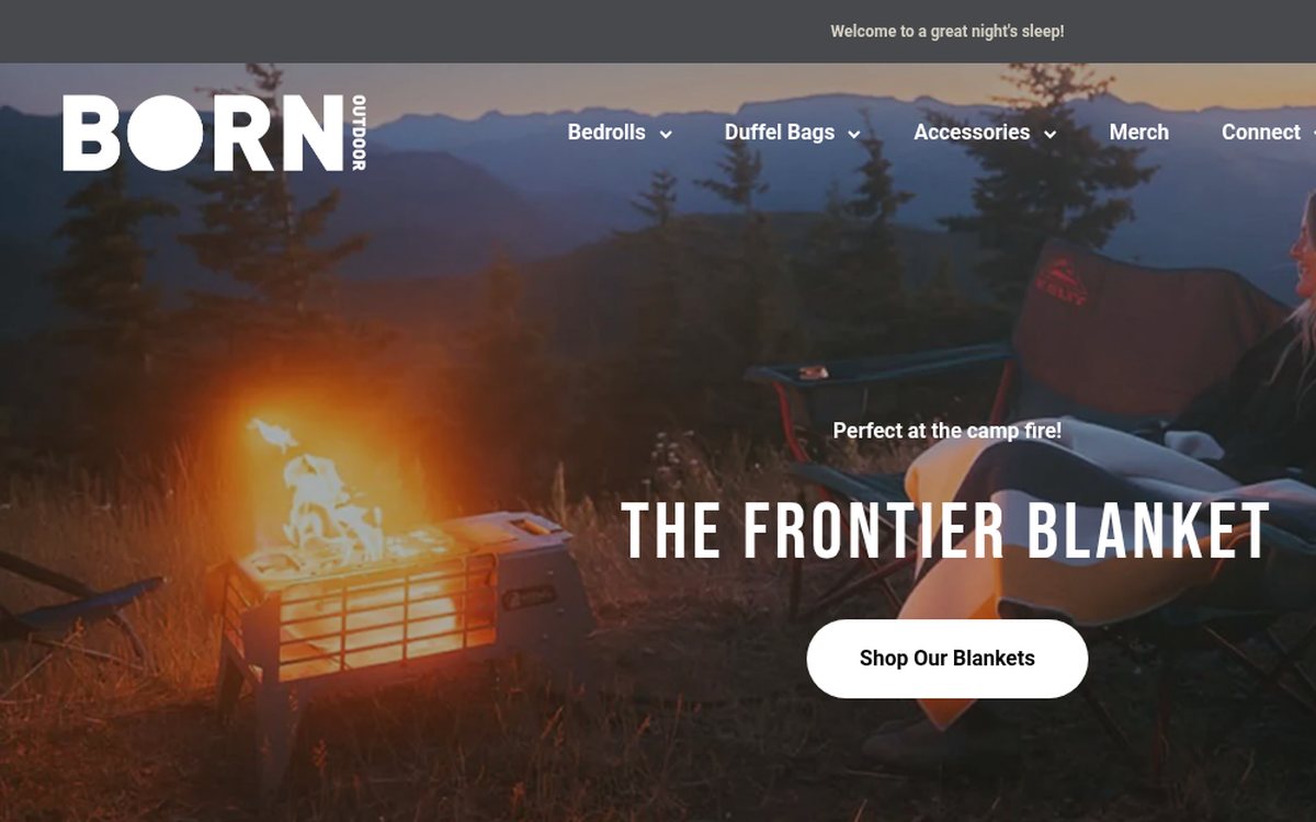 Born Outdoor homepage featuring the Frontier Blanket bedroll beside a campfire
