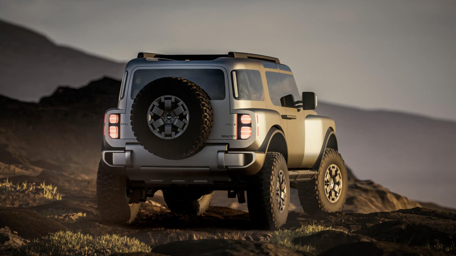 Rear three-quarter view of the Boulder concept showing the tailgate-mounted full-size spare and vertical tail lights