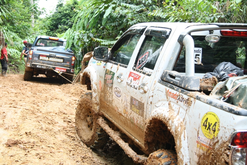 Four wheel drive vehicles in mud, towing 