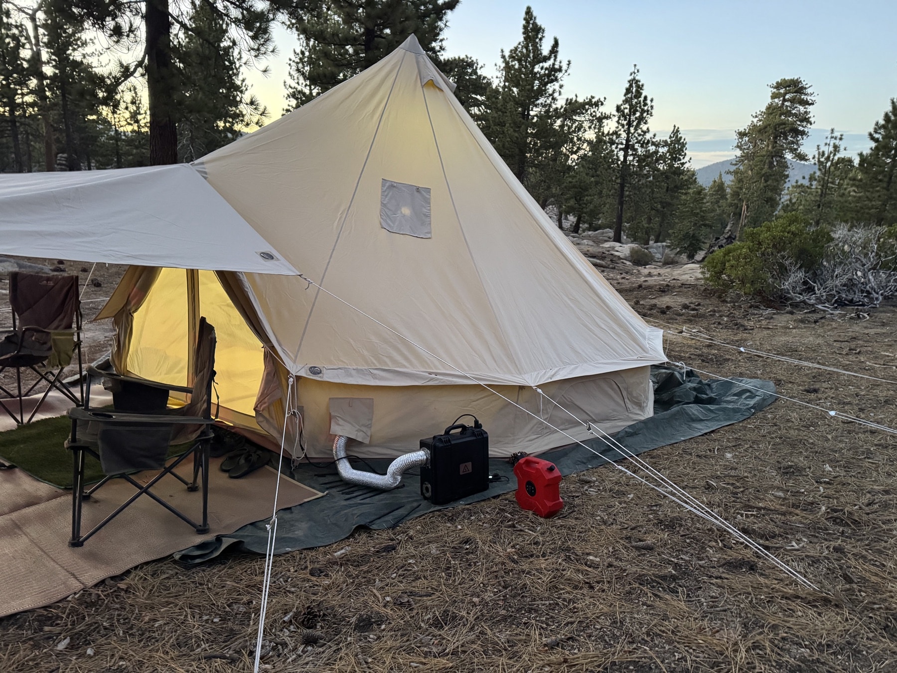 Velit camping portable heater on the side of a stout tent