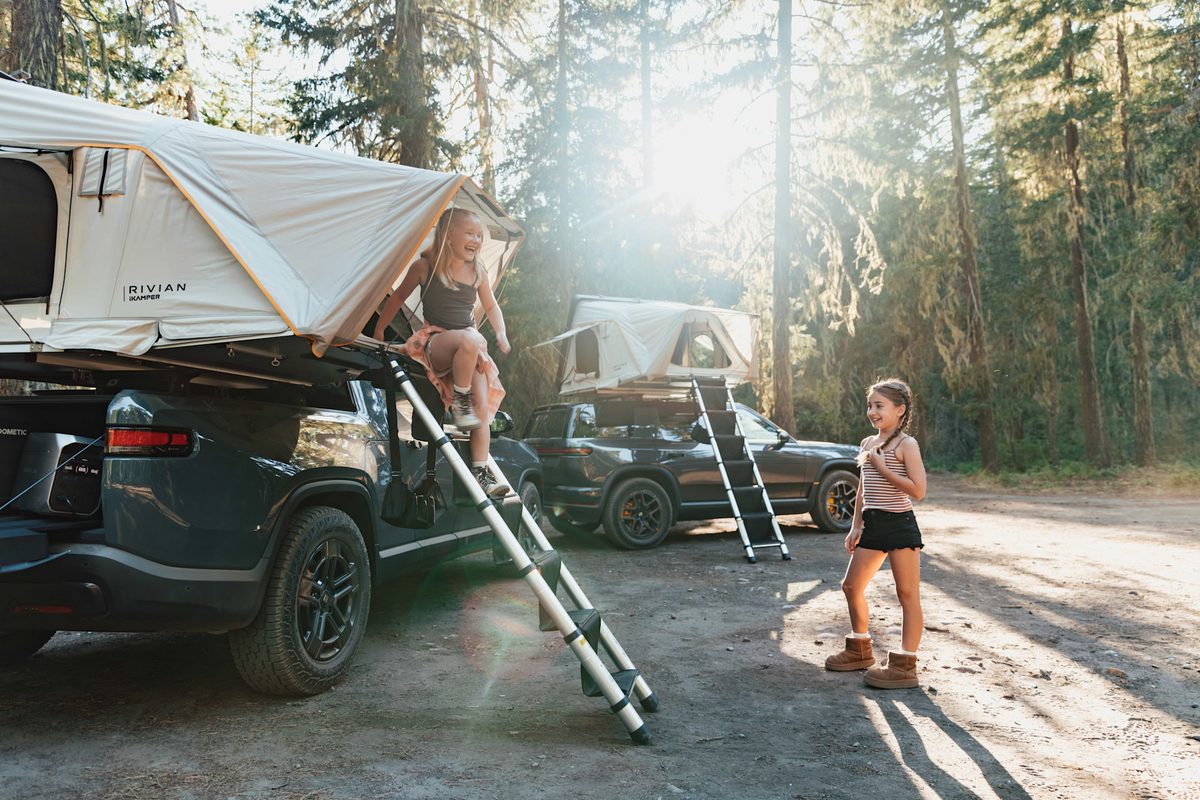 Rivian rooftop tent Duo over an R1T bed with a Trio on an R1S roof behind it