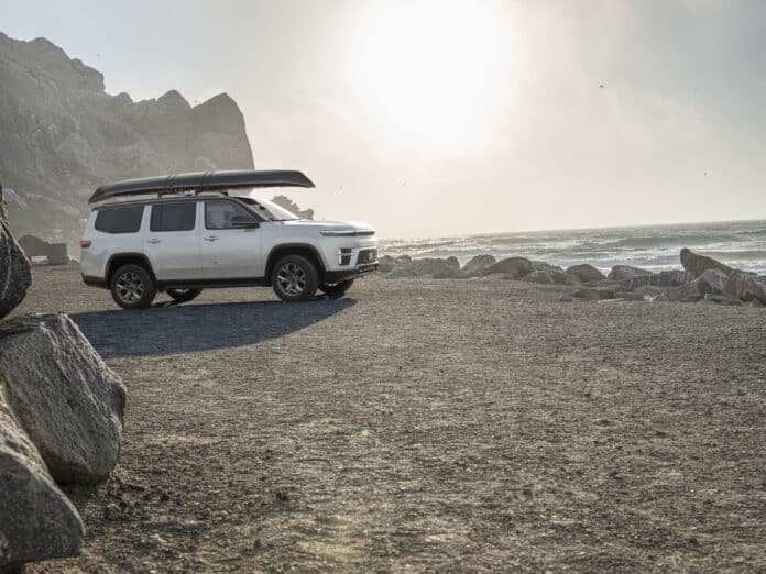 White 2026 Jeep Grand Wagoneer with a kayak strapped to its roof rack, the load case at the centre of the Jeep Wagoneer recall