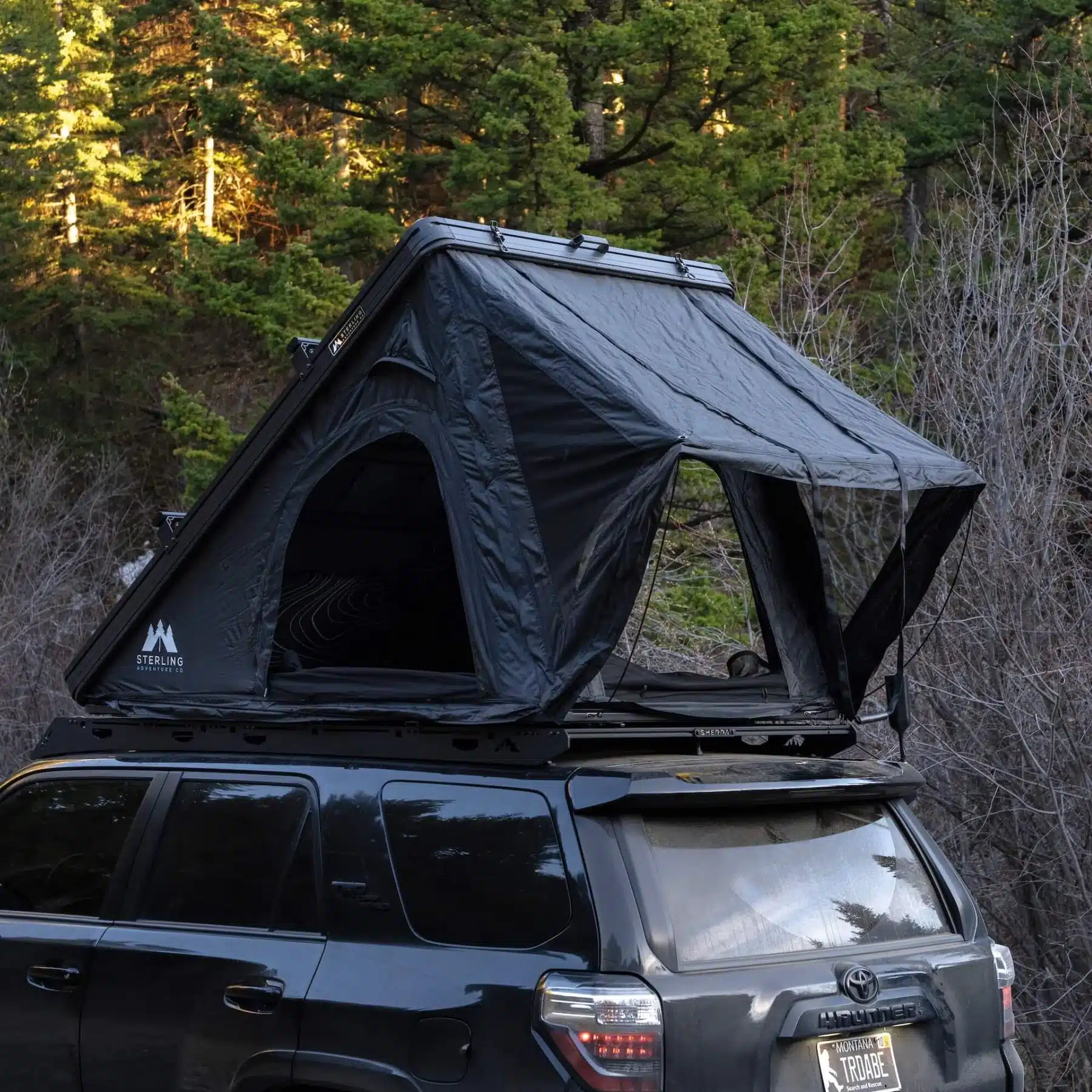 Wasatch Lite V2 rooftop tent open on a Toyota 4Runner with the rain fly extended on its two poles over a mesh window