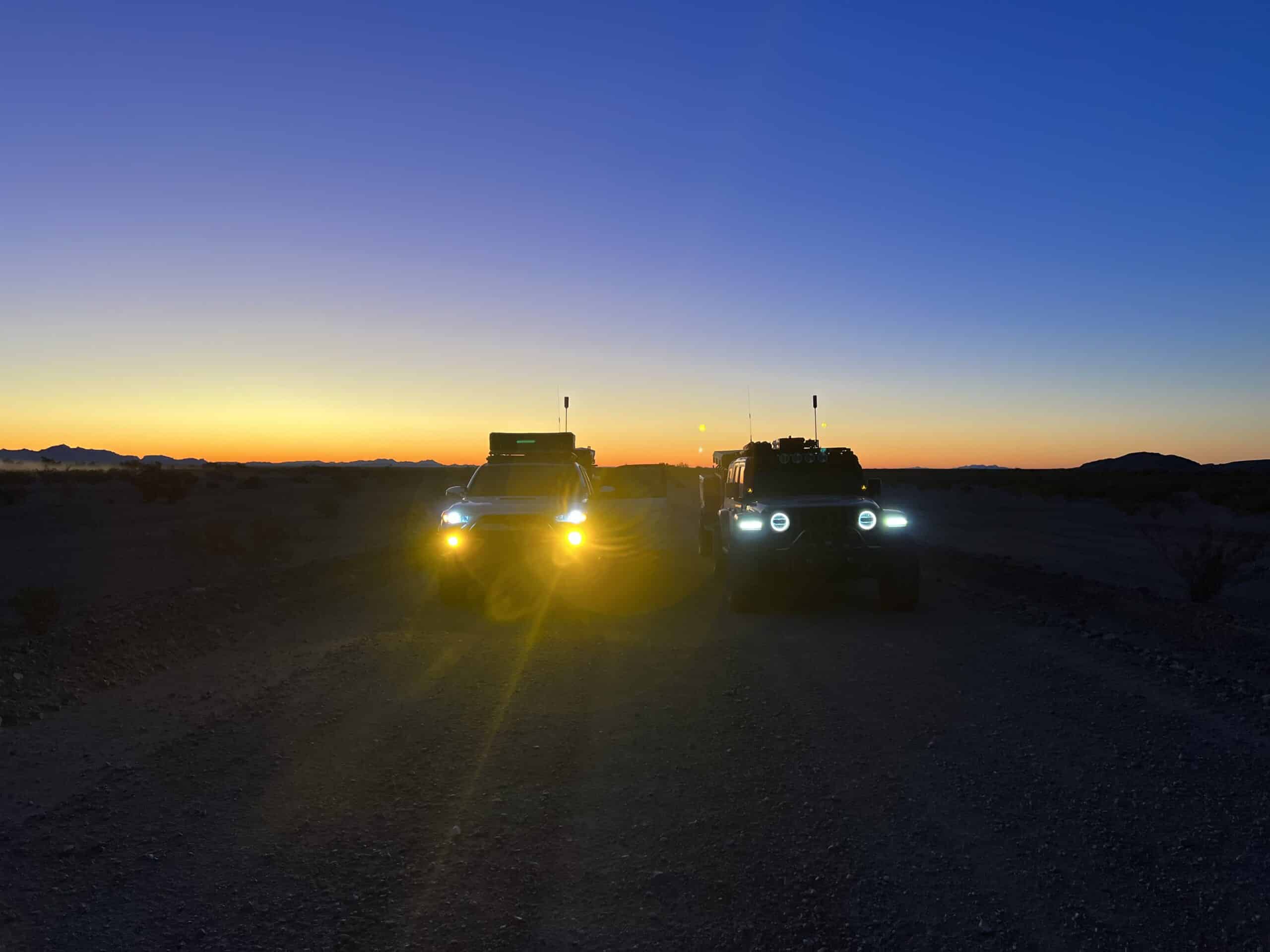 One off-road truck with amber lights and another with white lights
