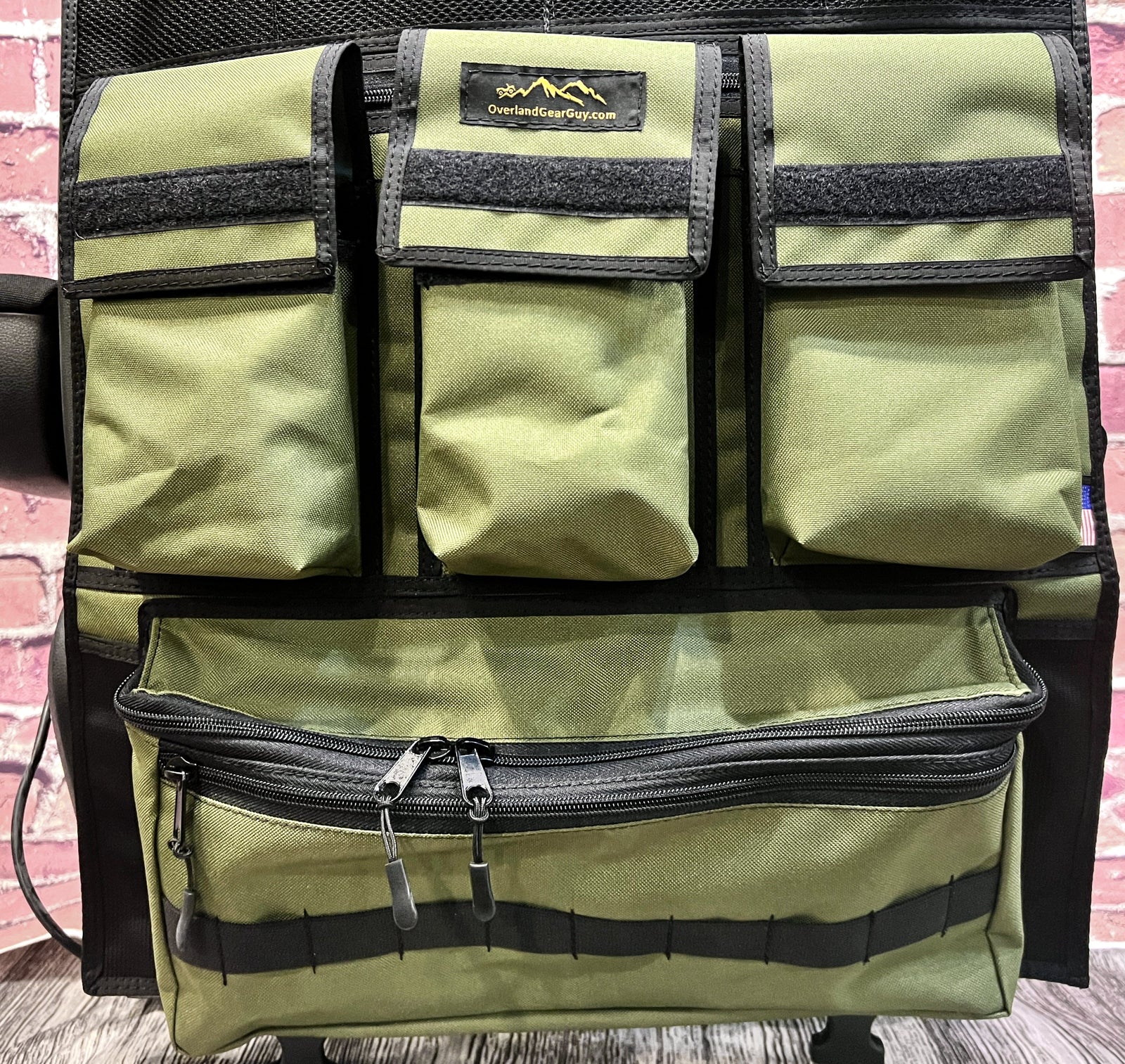 Olive drab Adventure Ready seat organizer with three box pockets and a zippered cargo pocket for Jeep Wrangler storage