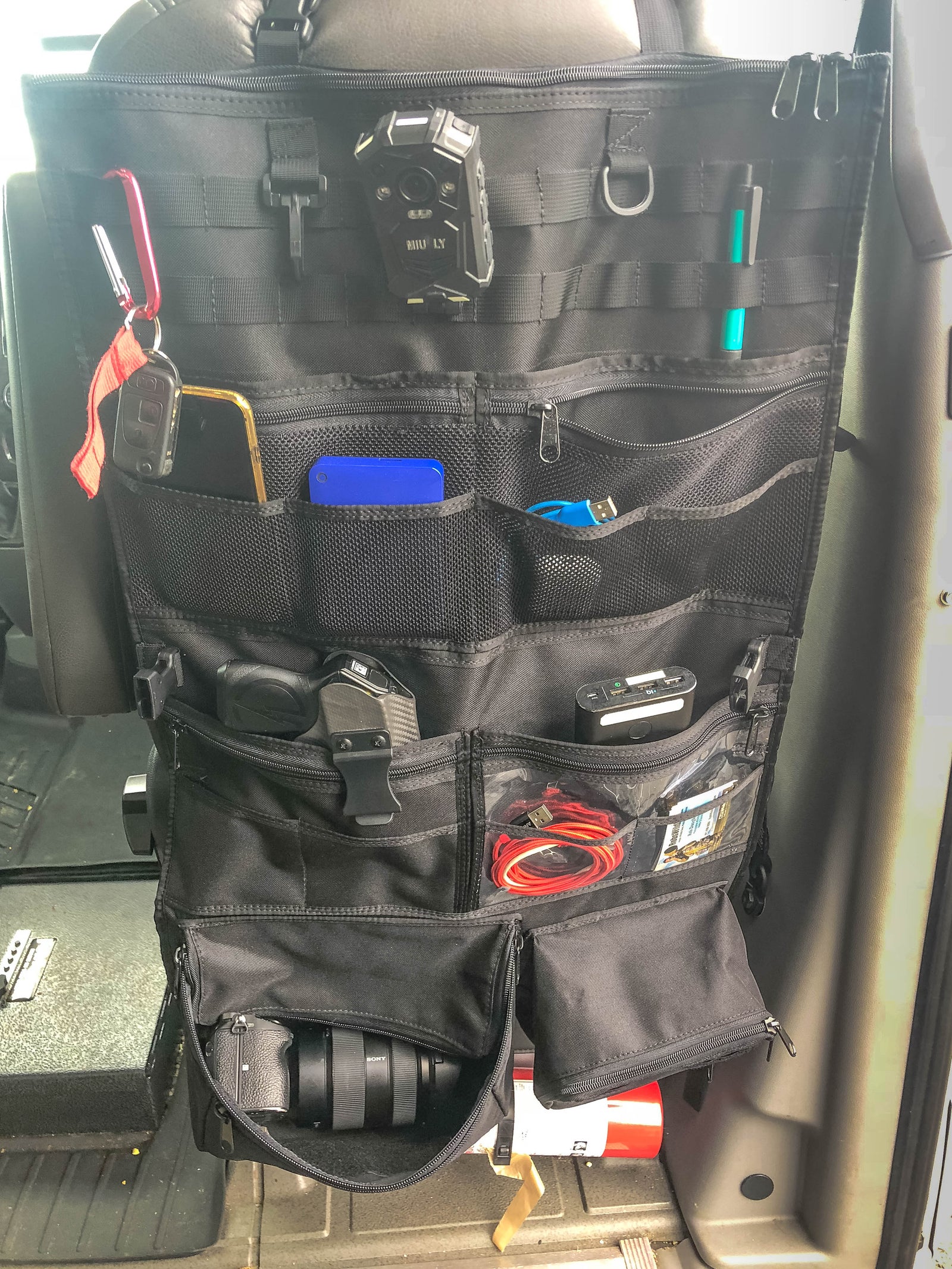 Adventure Ready 1 Seat Organizer on a seat back holding a flashlight, knife and small tools