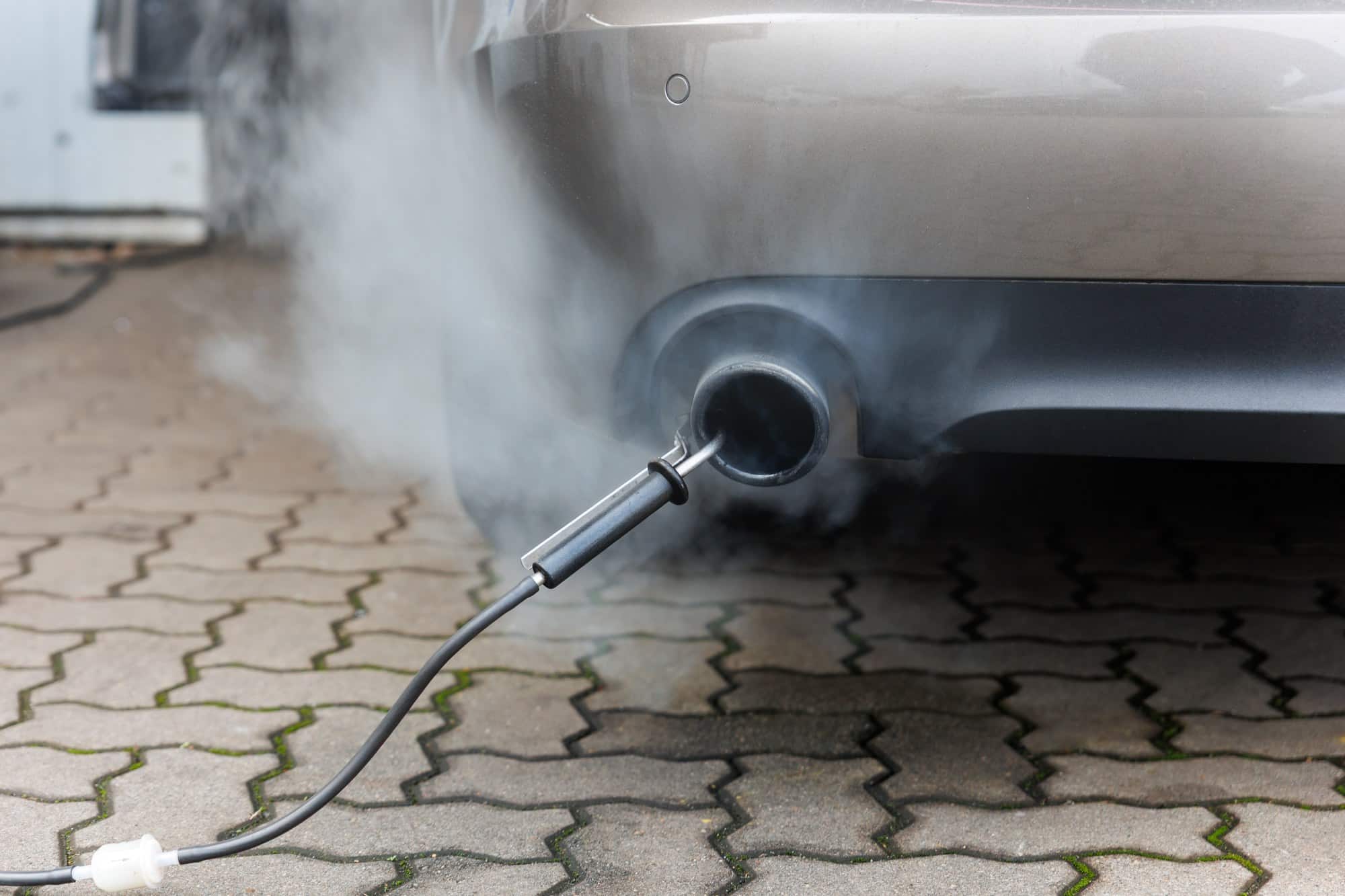 Smog test probe in a tailpipe Emissions test probe in a car tailpipe during a smog test