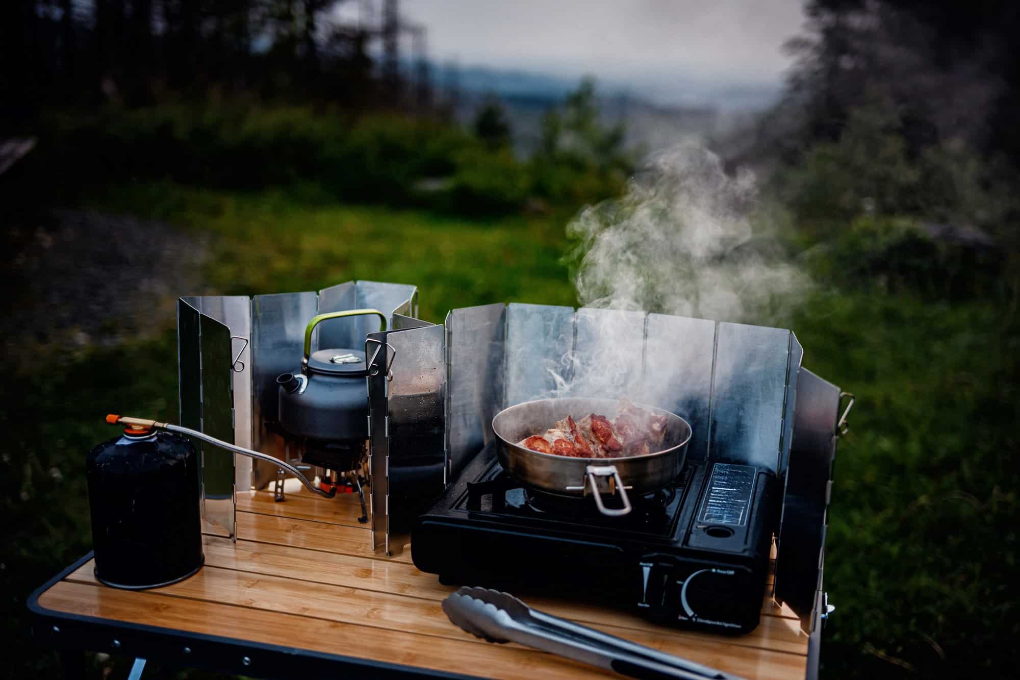 Cooking on a camp stove during a fire ban Gas camping stove cooking a skillet meal on a camp table