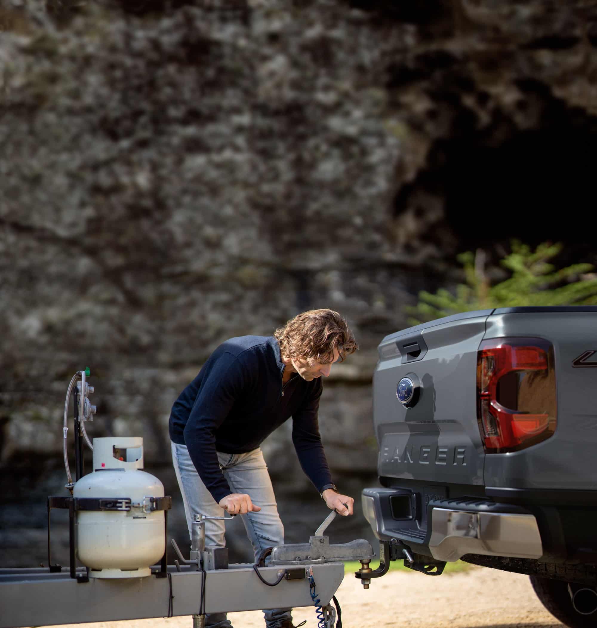 2026 Ford Ranger XL hitching a trailer Owner hitching a trailer to a gray 2026 Ford Ranger XL, a trim sold with the 10.1-inch center screen