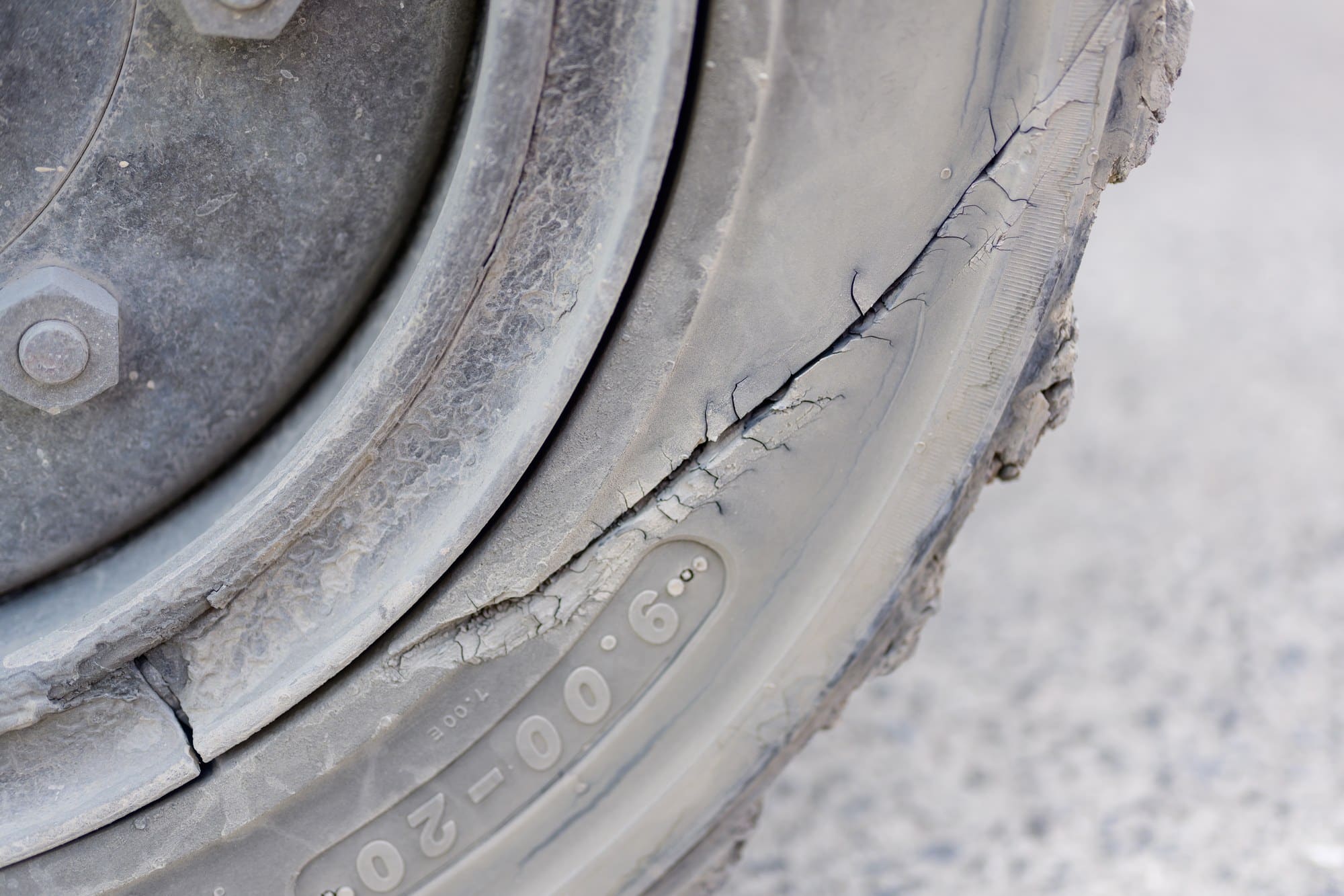 Sidewall damage on a tire Cracked and cut sidewall on a worn tire near the rim