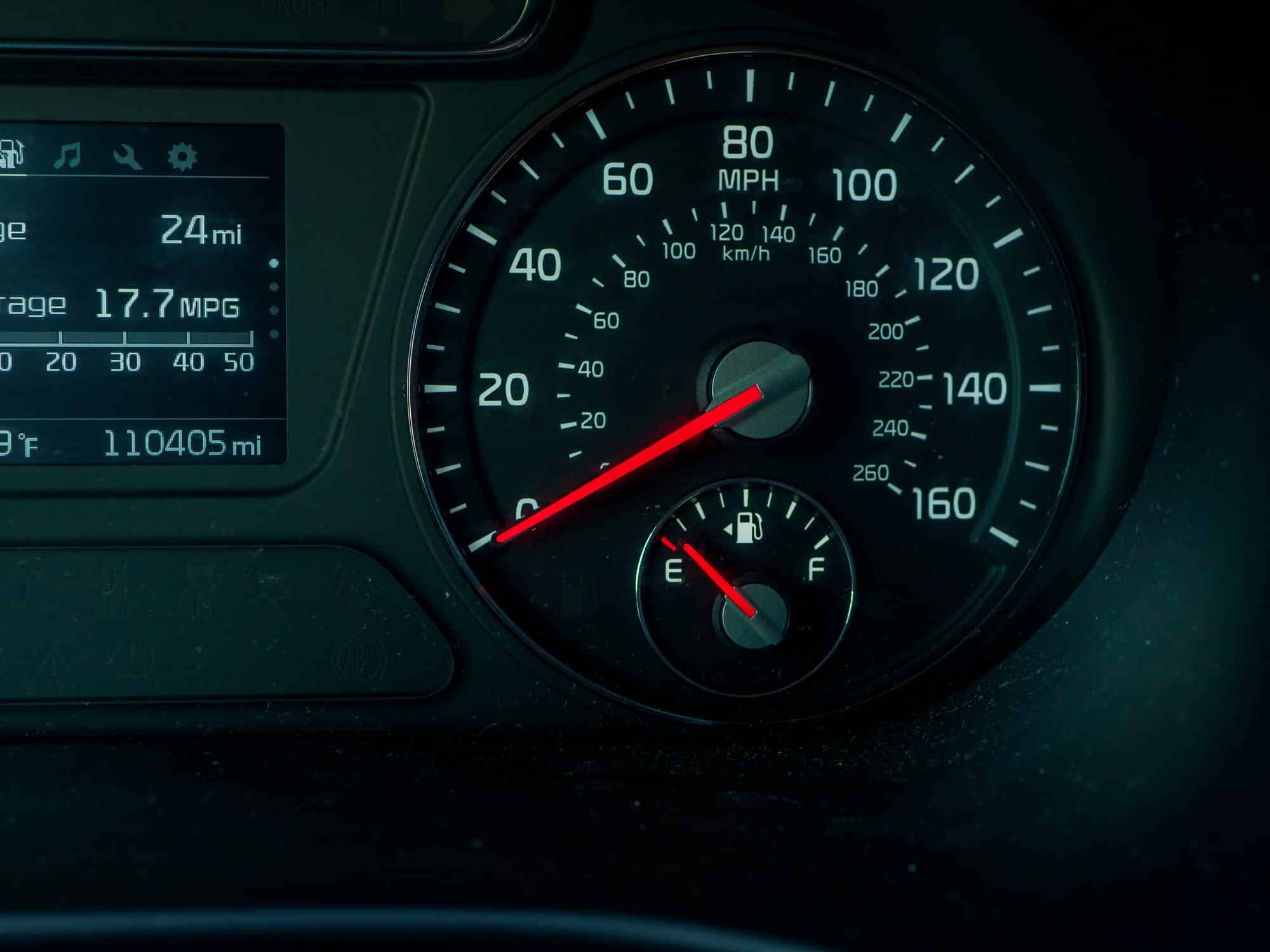 Dashboard gauge cluster showing a 17.7 MPG fuel economy average