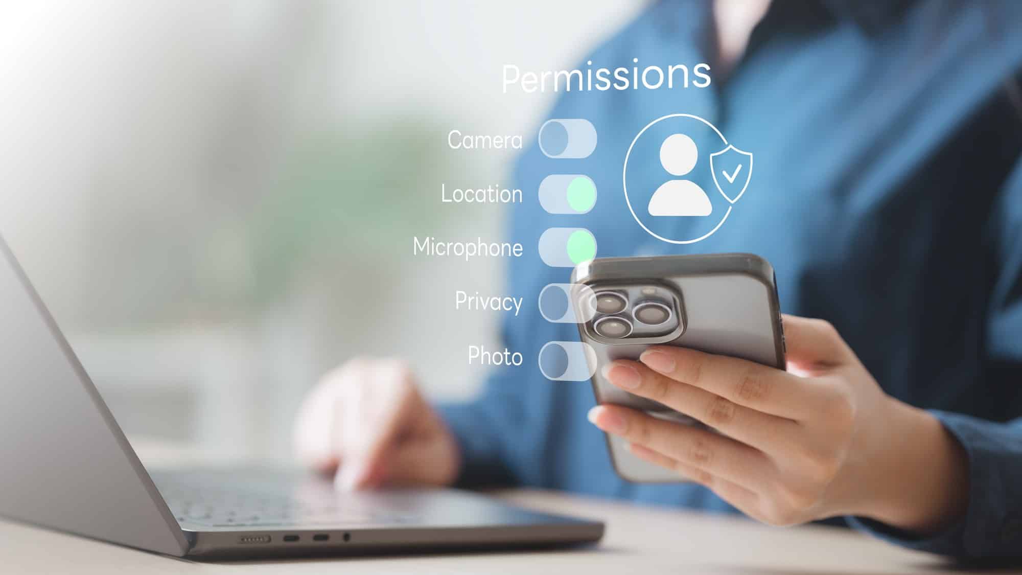 App permission and privacy settings on a phone Hand holding a phone with app permission toggles for location and privacy, tied to connected car data opt-outs