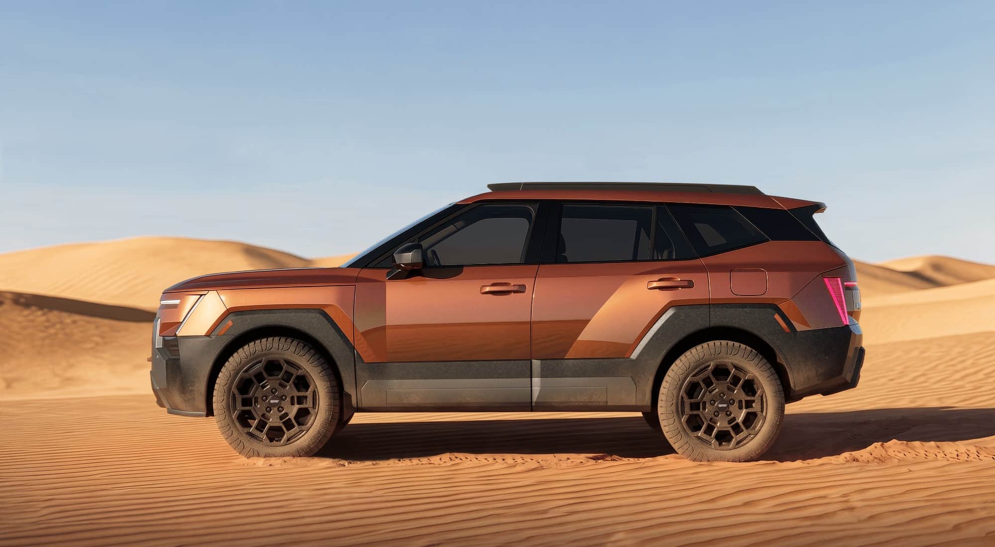 Tucson XRT Pro side profile Side profile of the 2027 Hyundai Tucson XRT Pro on sand dunes, showing its ride height and all-terrain tires