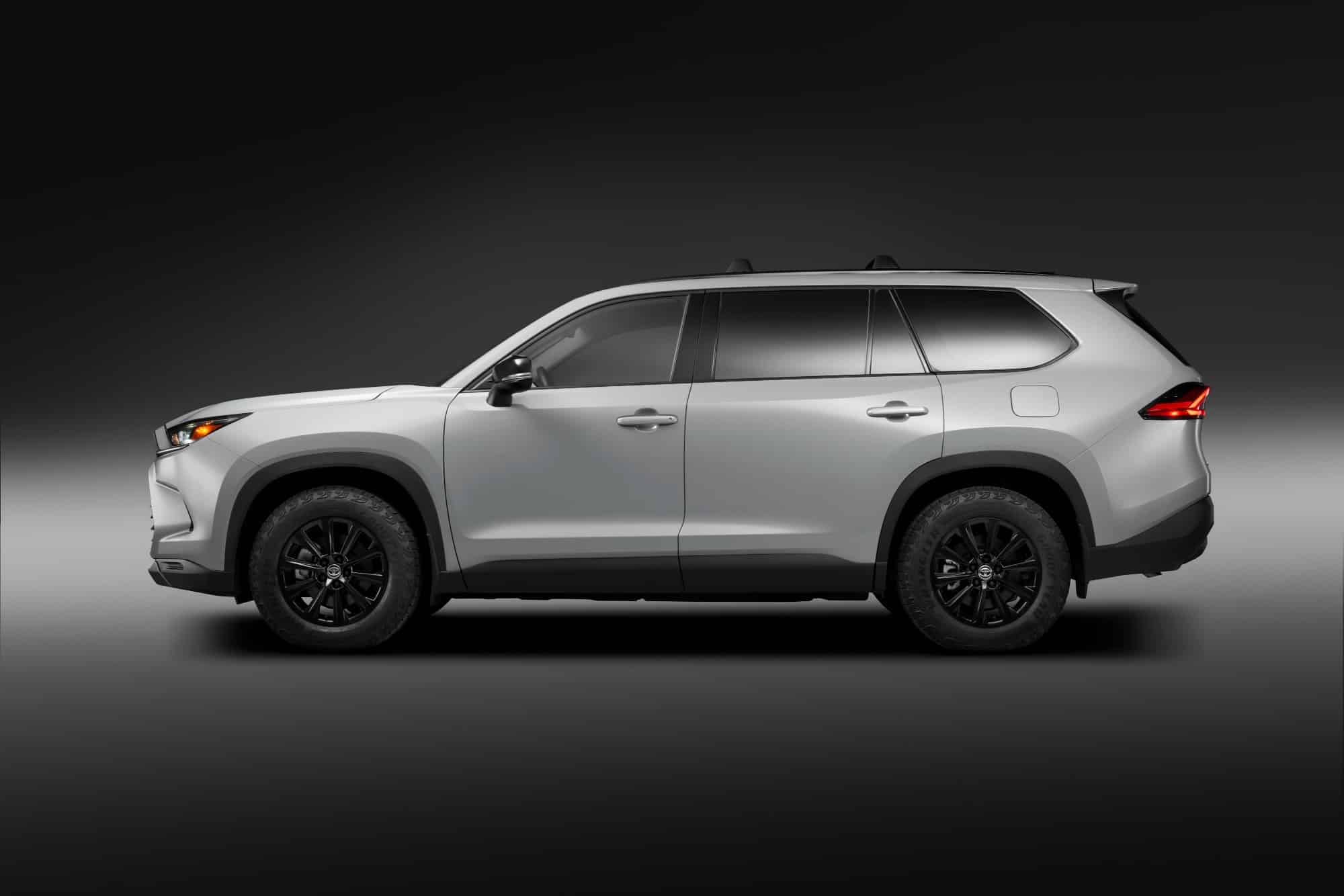 Three-row Toyota hybrid SUV on matte black wheels with all-terrain tires