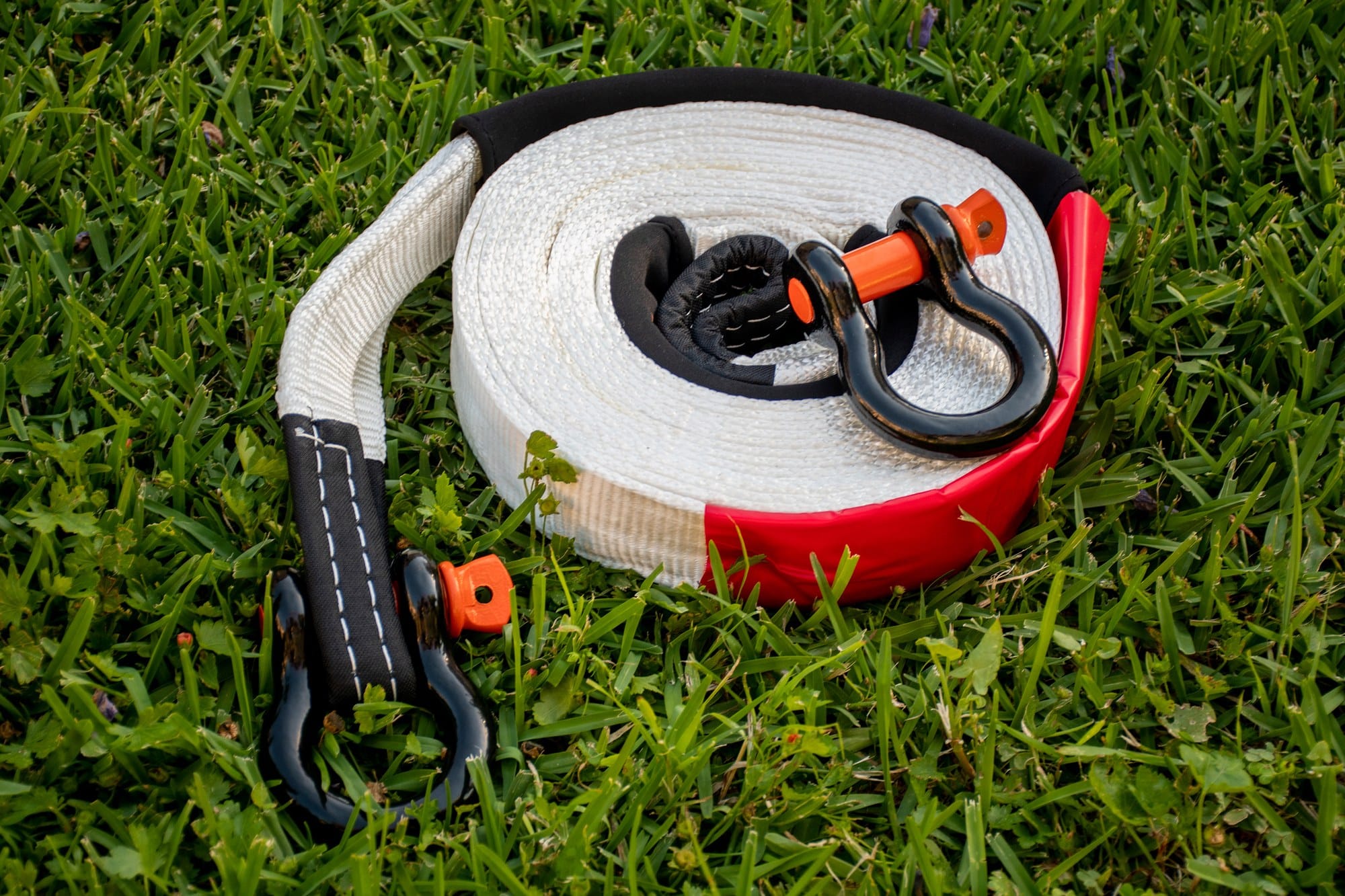 Recovery strap and shackles Snatch strap and bow shackles from a 4x4 recovery kit laid on grass