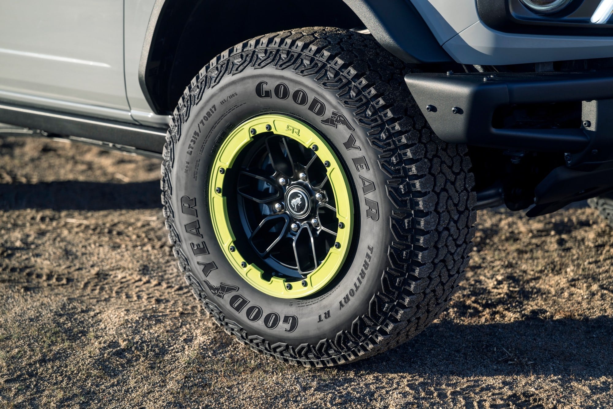 2027 Ford Bronco RTR beadlock-capable wheel with a lime ring and a Goodyear all-terrain tire