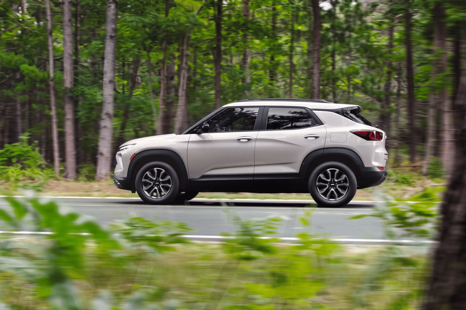 Trailblazer Z71 capability 2027 Chevrolet Trailblazer driving on a paved road through a forest