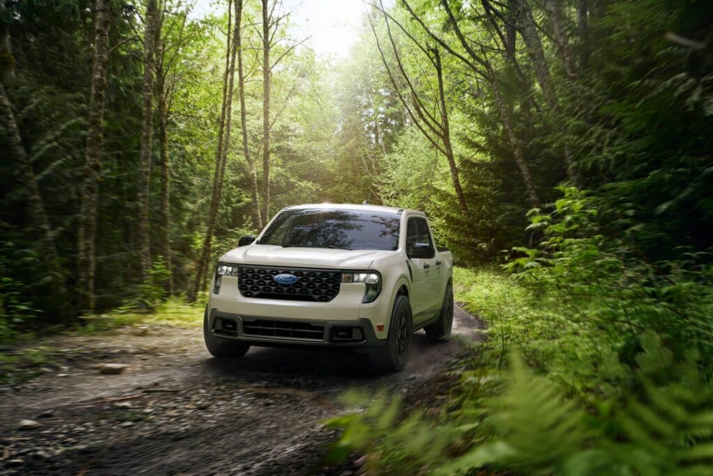 Ford Maverick XLT with the Maverick FX4 package in Desert Sand on a forest trail