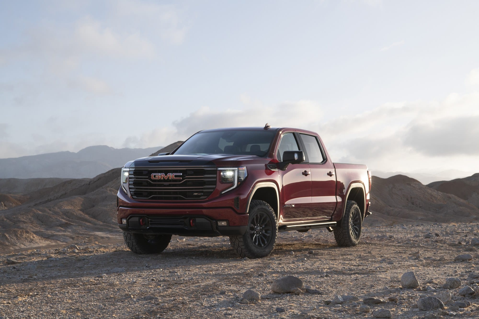Red 2022 GMC Sierra AT4X parked on rocky desert ground