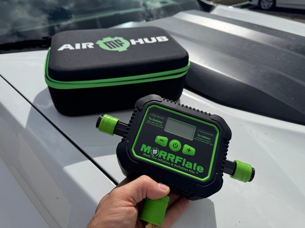 Air Hub and Hard-Shell Storage Case MORRFlate Air Hub held in front of its hard-shell storage case on a truck hood