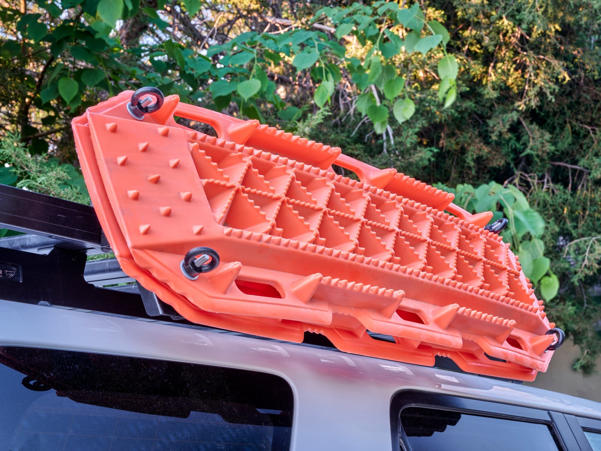 Traction boards on an SUV roof rack Orange recovery traction boards mounted on an SUV roof rack
