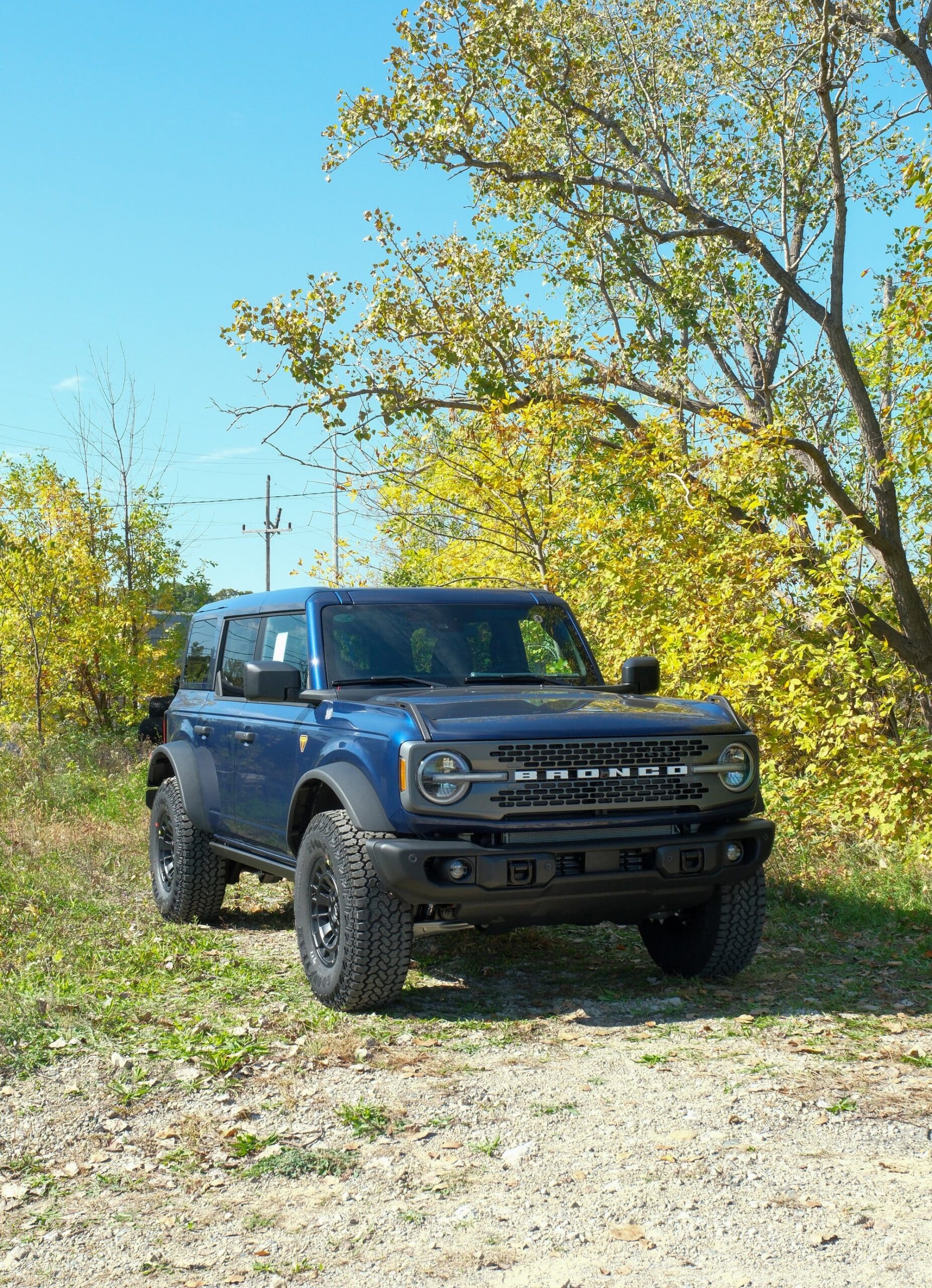 2027 Bronco in blue Blue 2027 Ford Bronco four-door parked on a gravel clearing