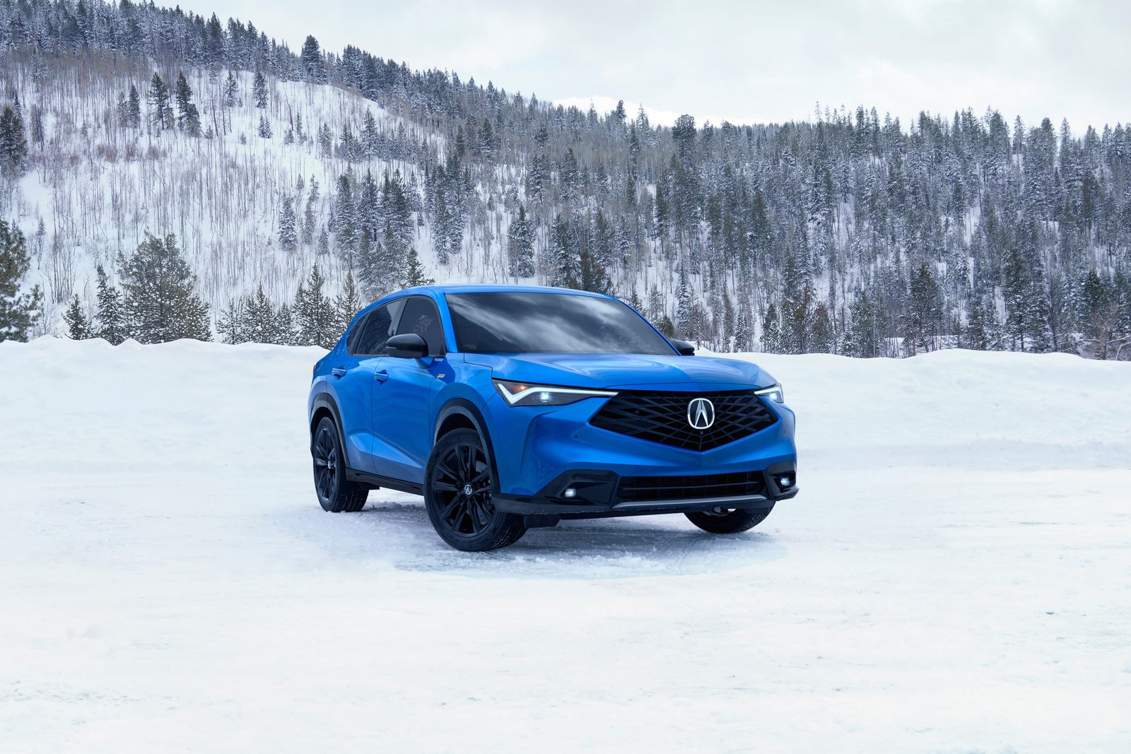 Acura ADX A-Spec in snow Blue Acura ADX A-Spec parked on snow in front of a forested hillside