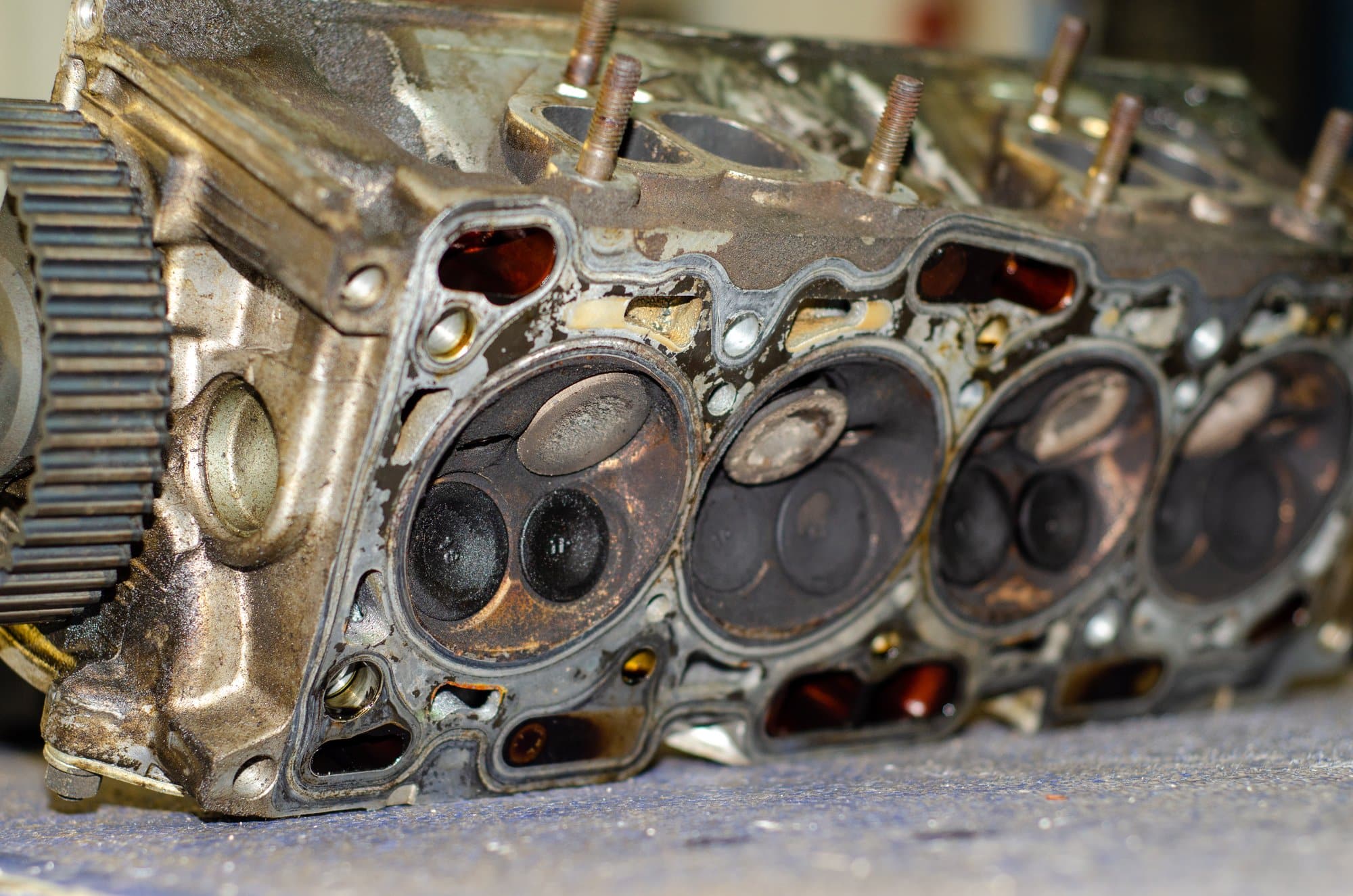 Removed engine cylinder head Removed engine cylinder head with stained combustion chambers and valves
