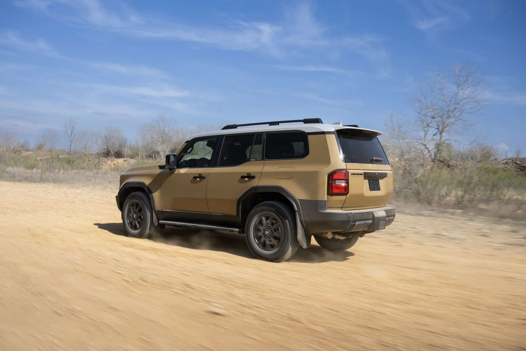 2027 Toyota Land Cruiser Trail Dust 2027 Toyota Land Cruiser in Trail Dust driving on a dirt road